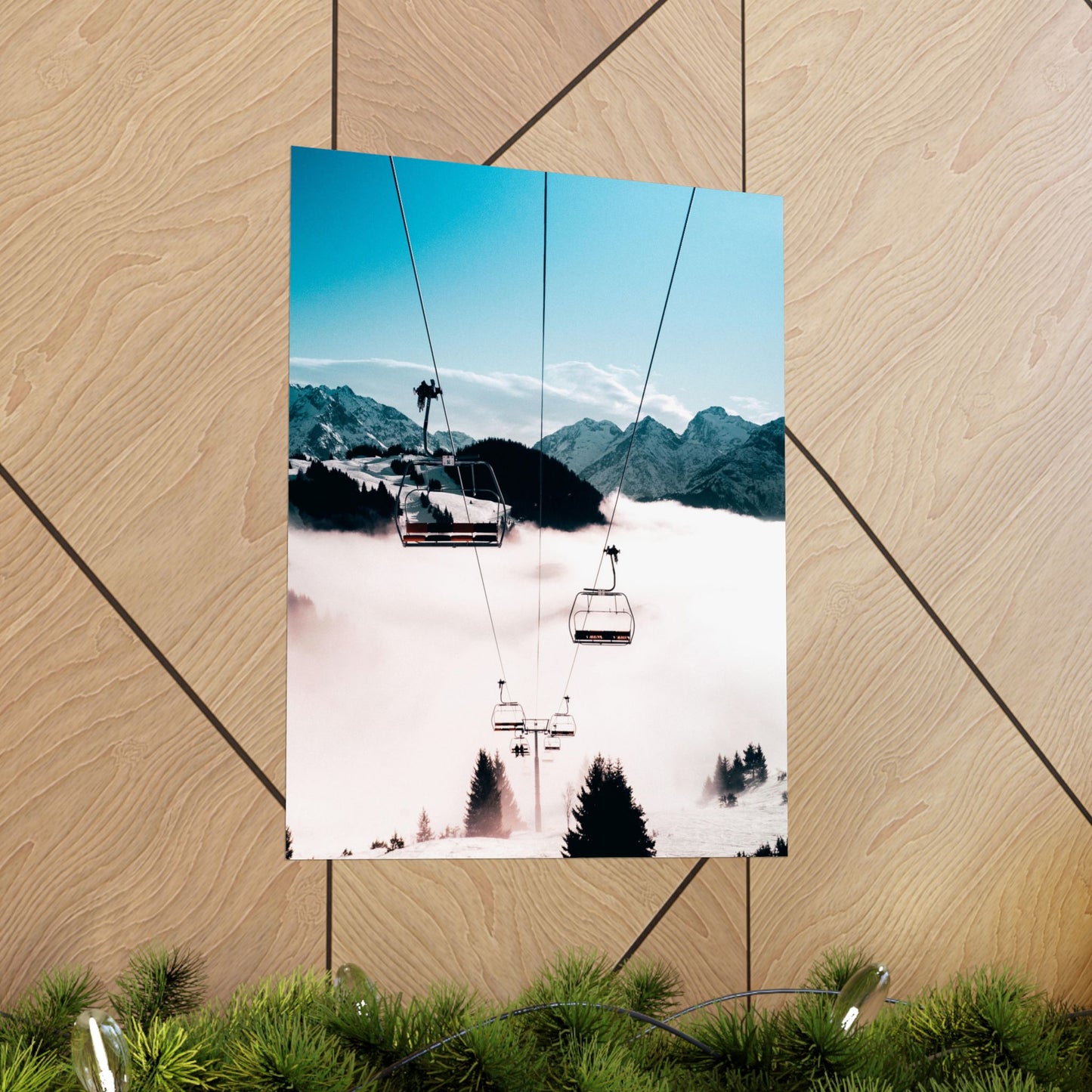 Poster of a snowy mountain landscape with a ski lift on a wooden surface.