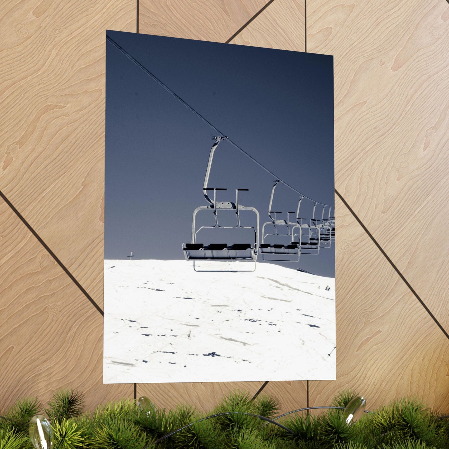 Ski lift chairs on a snowy mountain with a clear blue sky.