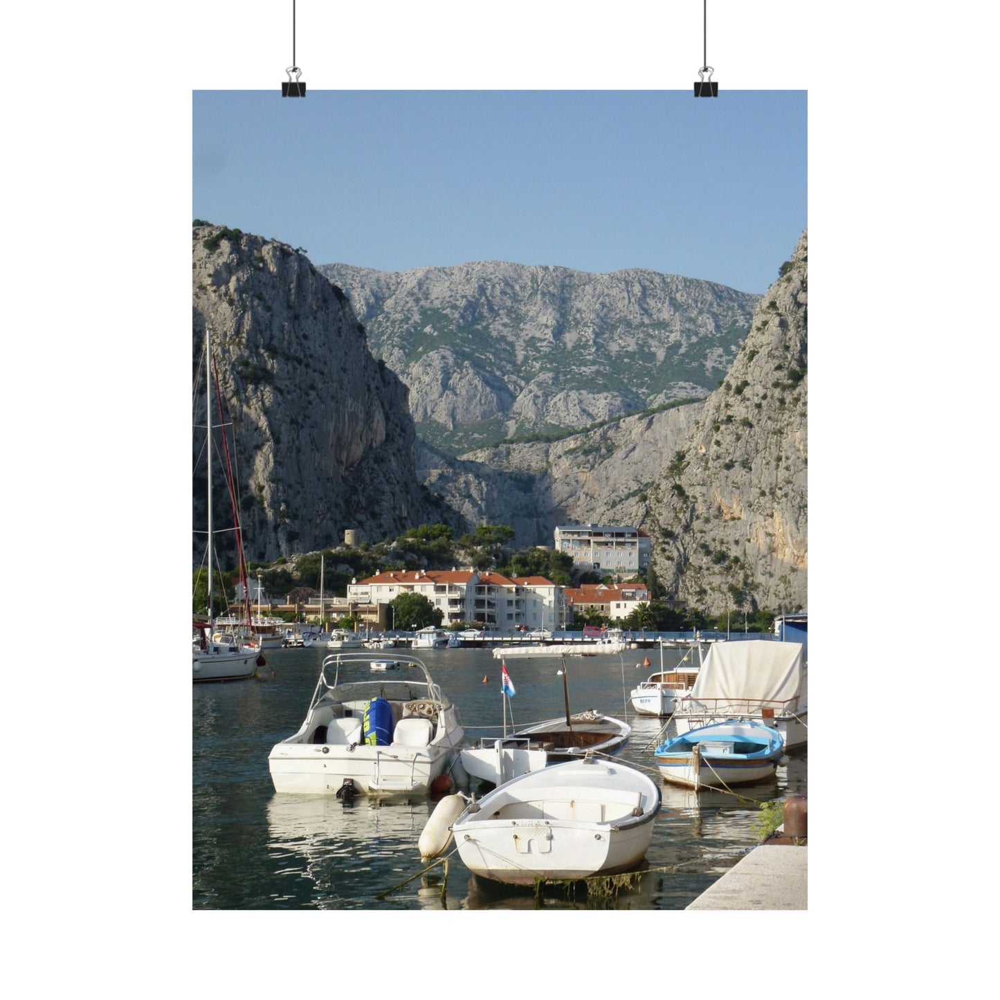 Harbor scene with boats and mountains in the background