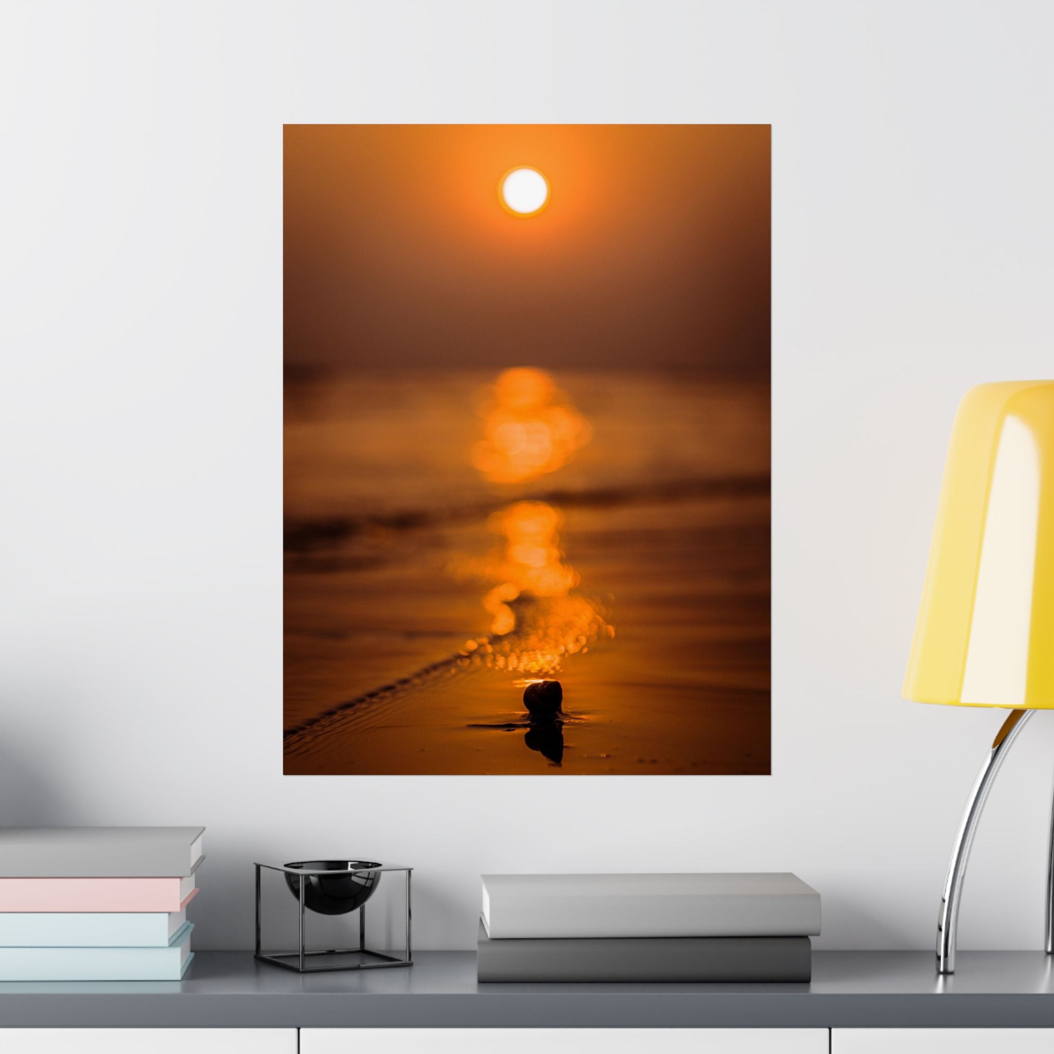 Sunset over water with a lamp and books on a shelf