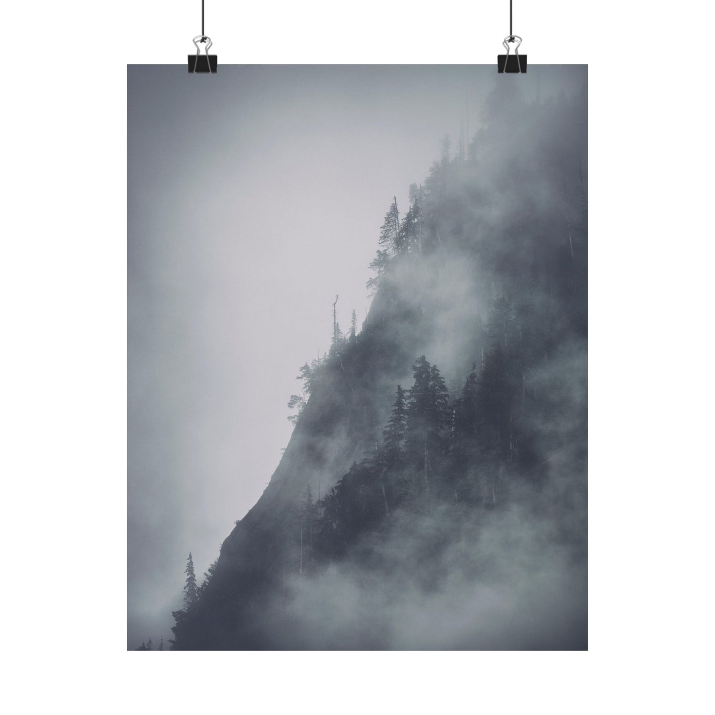 Mountain covered in mist with trees, hanging on a white background