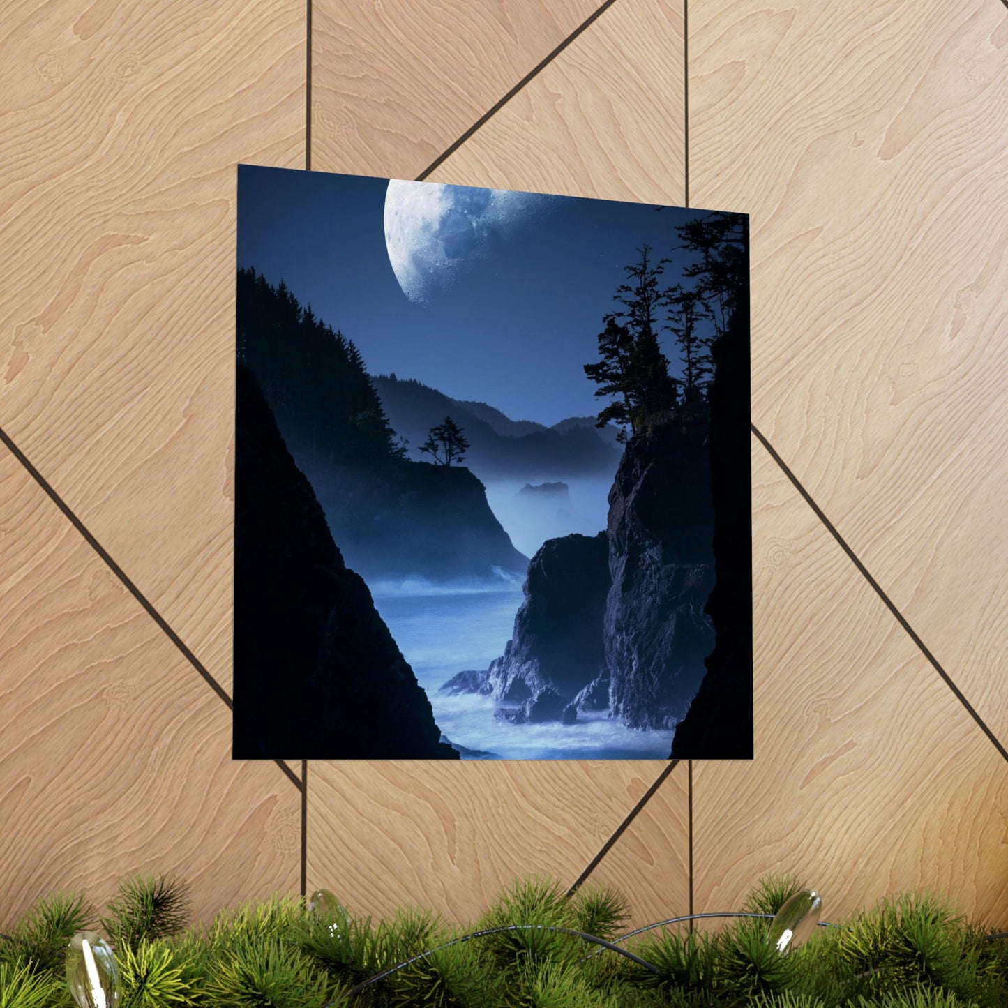 Poster of a mountain landscape with a moonlit sky on a wooden floor.