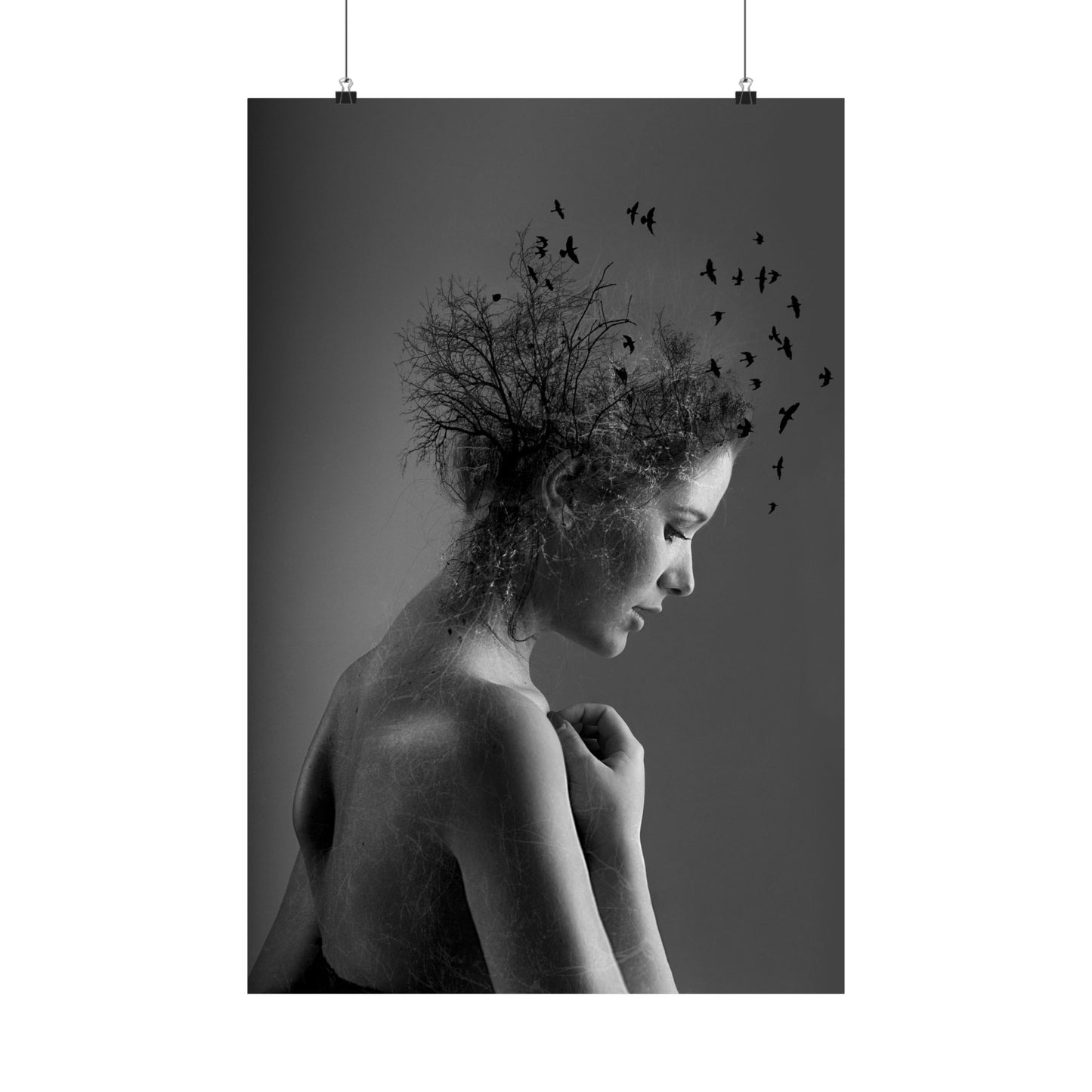 Black and white art print of a woman with birds in her hair on a dark background