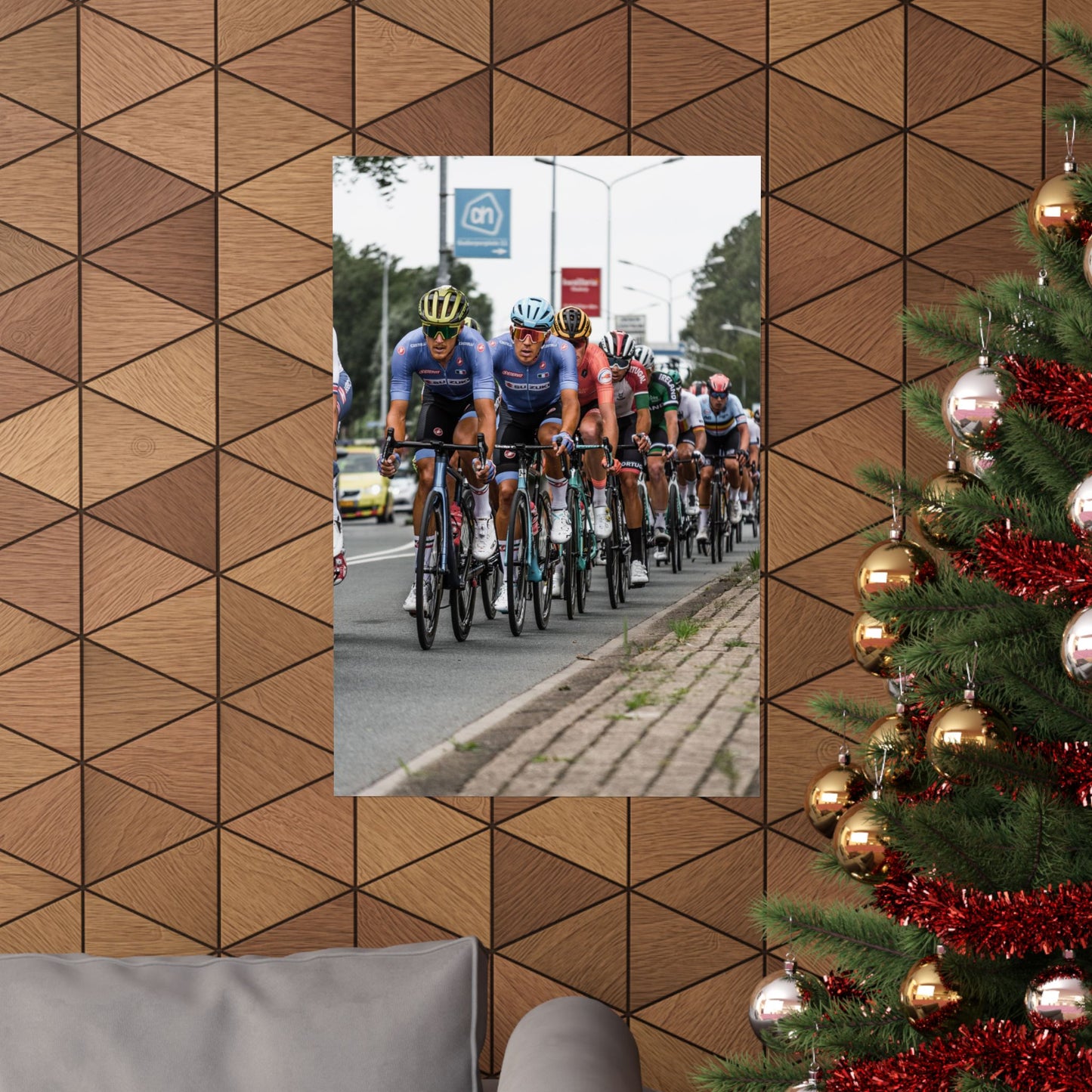 Bicycle race on a street reflected in a mirror with a Christmas tree on the right.