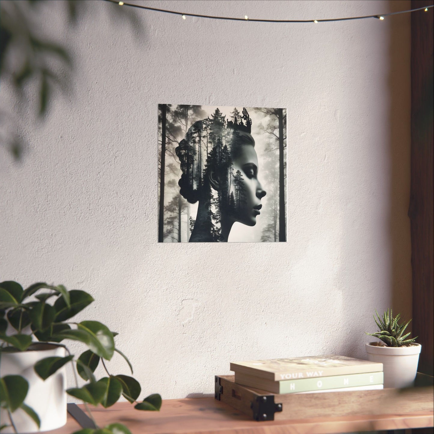 Poster of a woman with nature elements on a wall above a wooden desk with plants and books.