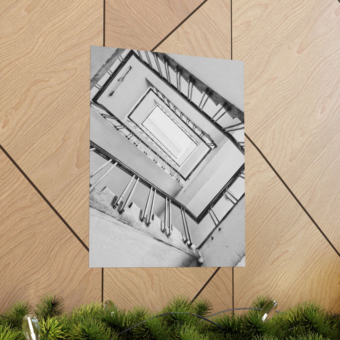 Poster of a staircase on a wooden floor with green plants at the bottom.