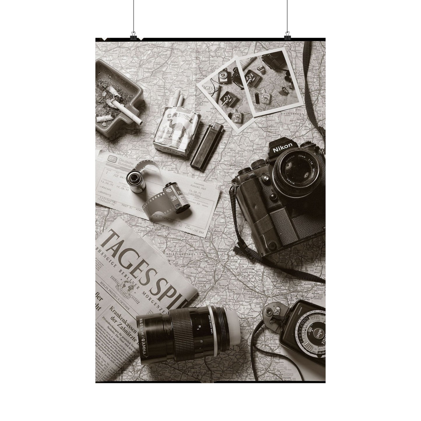 Vintage camera and film equipment on a map with 'Tagespiegel' newspaper