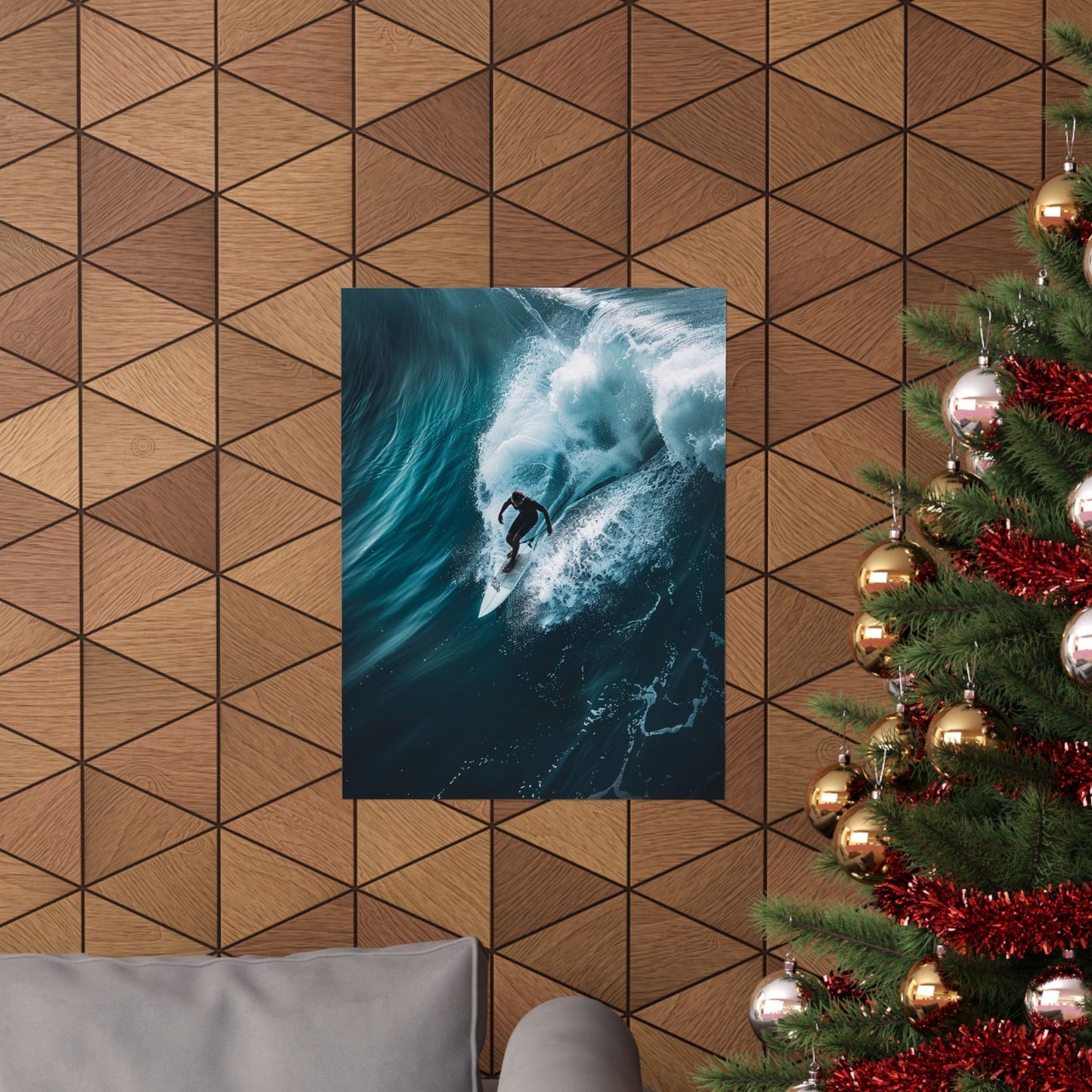 Poster of a surfer on a wave hanging on a geometric-patterned wall with a Christmas tree to the right.