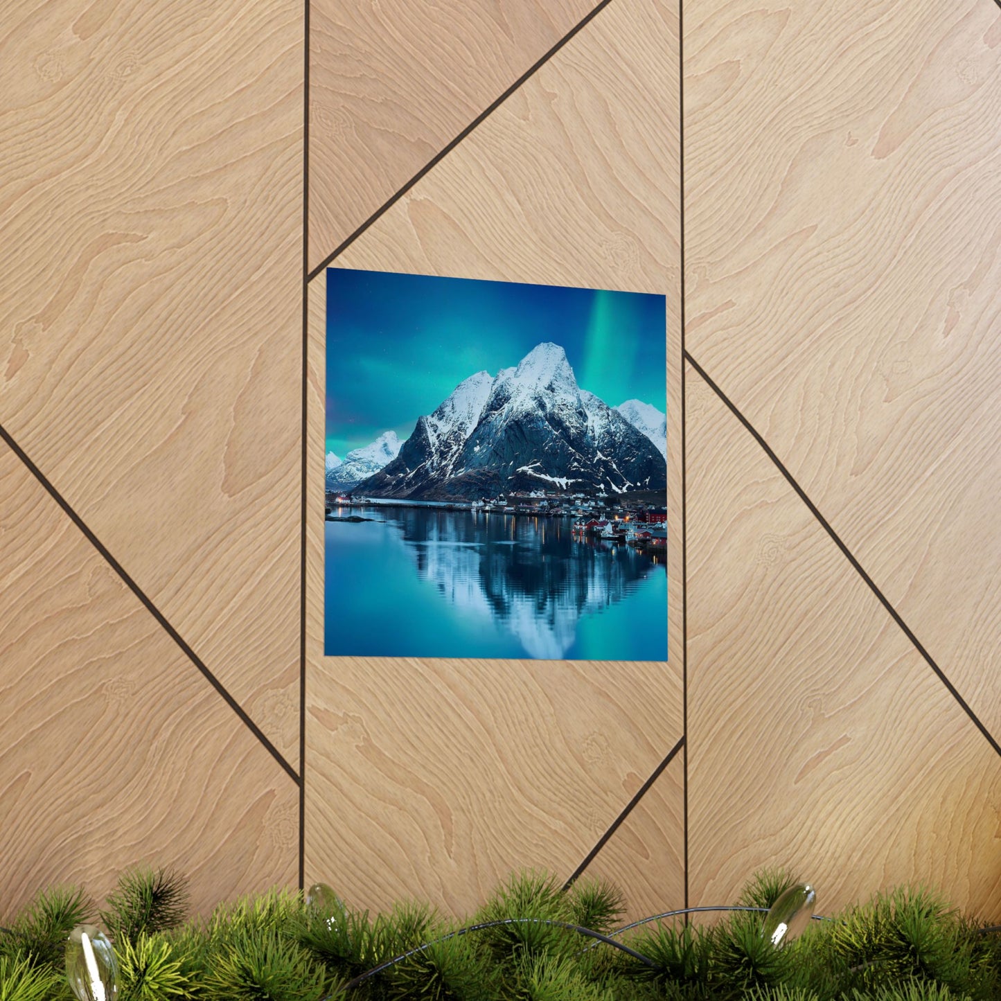 Framed photograph of a mountain landscape with a lake on a wooden wall.