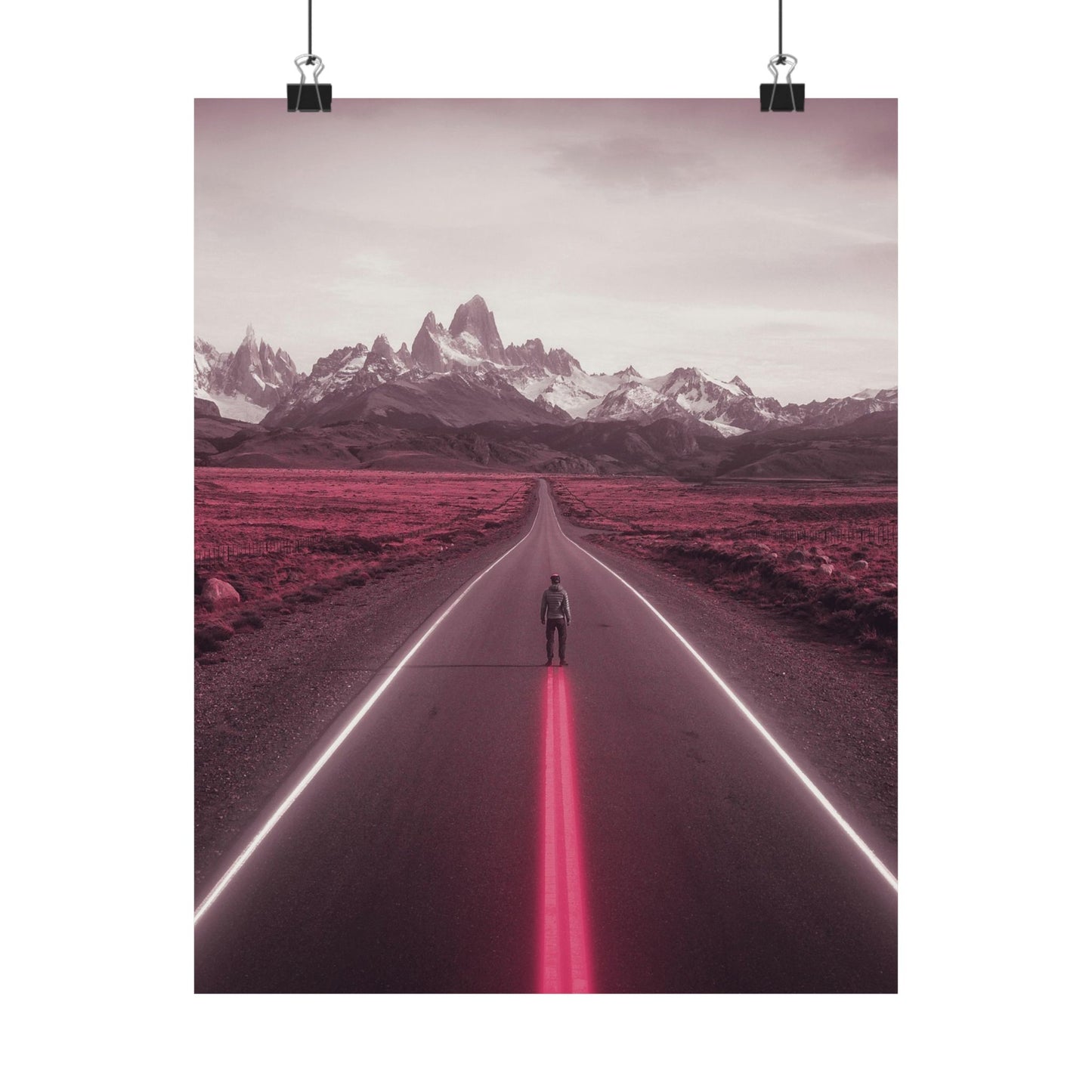 Person standing at the end of a road with a mountainous landscape in pink and purple tones