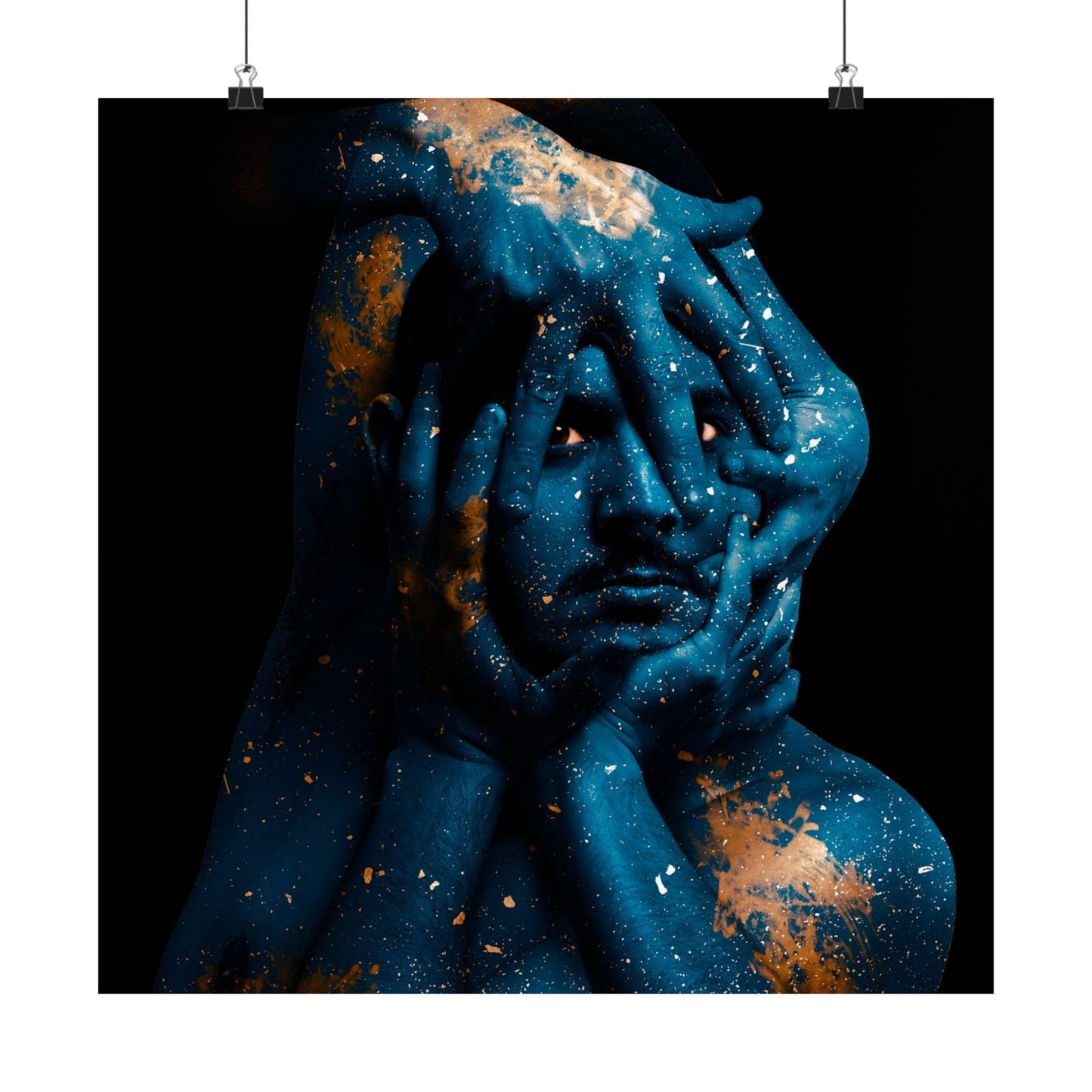 Artistic depiction of a person with cosmic design, hands covering face, on a black background