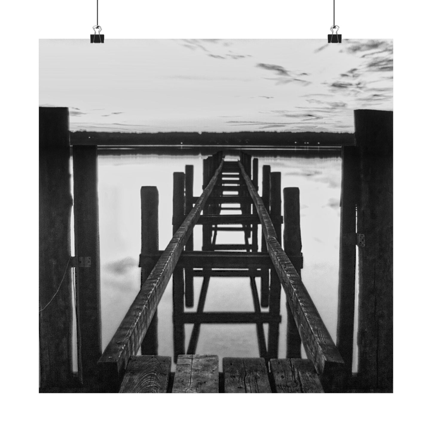 Black and white photo of a wooden pier extending into water