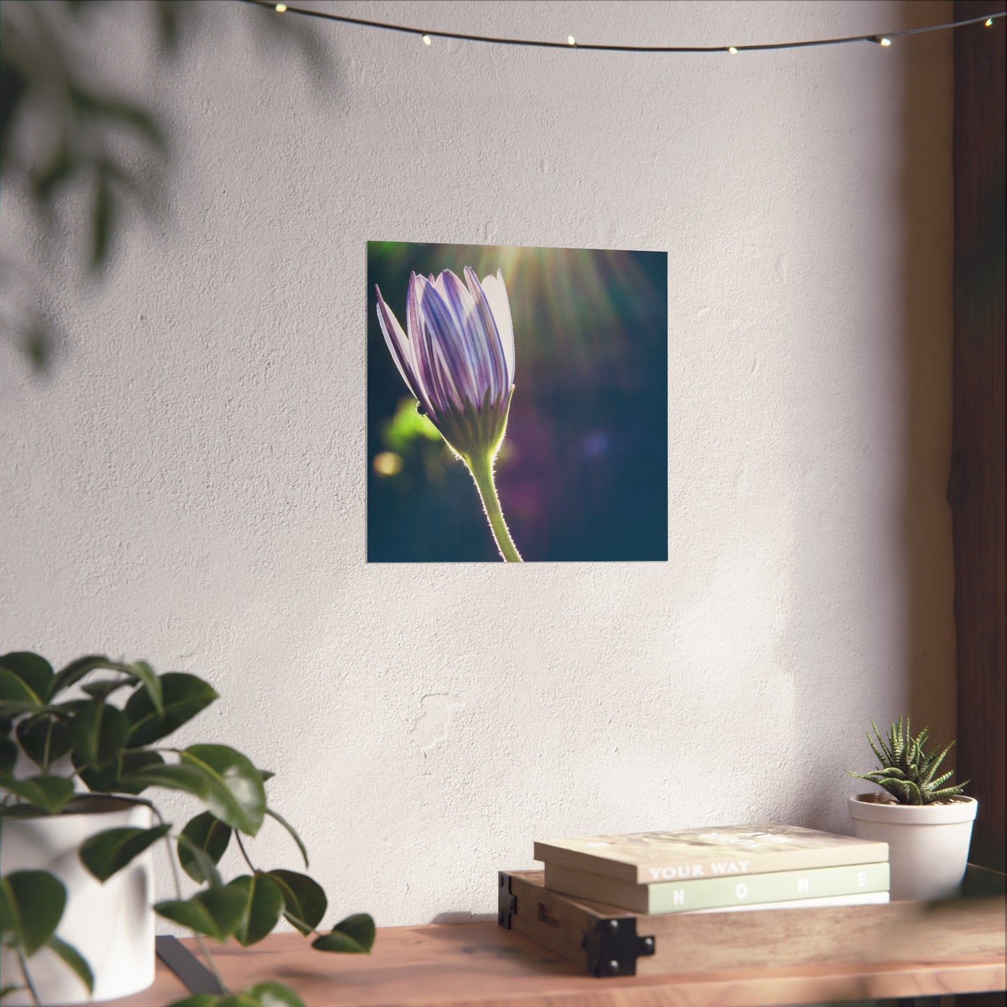 Flower poster on a wall with a desk and plants below