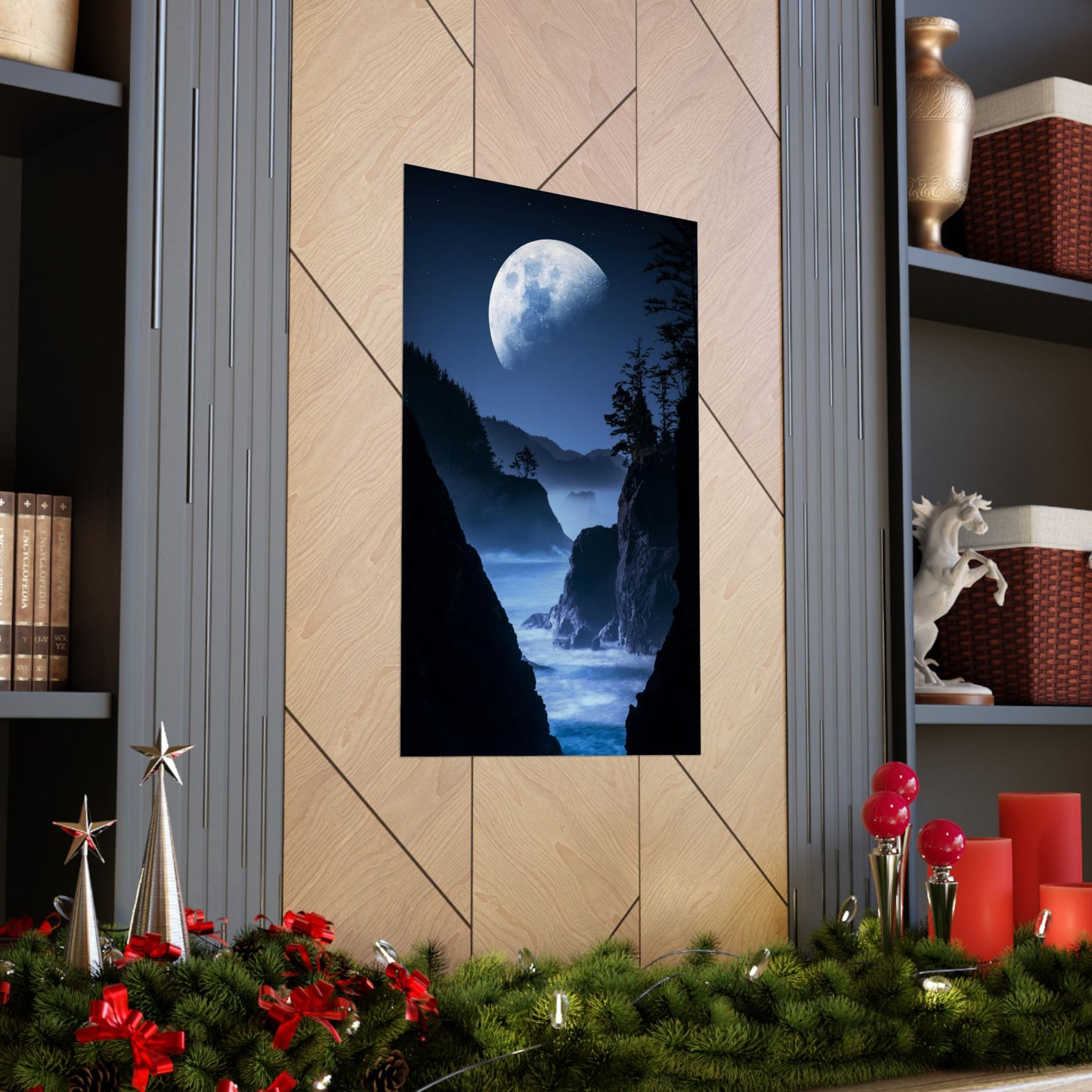 Framed artwork of a moonlit landscape on a wall with decorative elements below.
