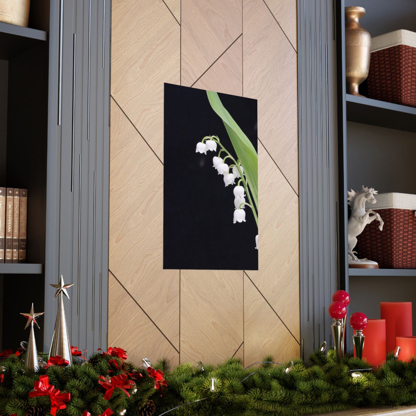 Decorative wall art of white flowers on a black background in a home setting with festive decorations.