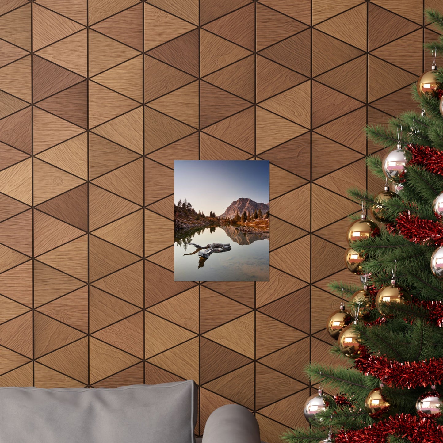 Wooden wall paneling with a framed picture and a decorated Christmas tree.