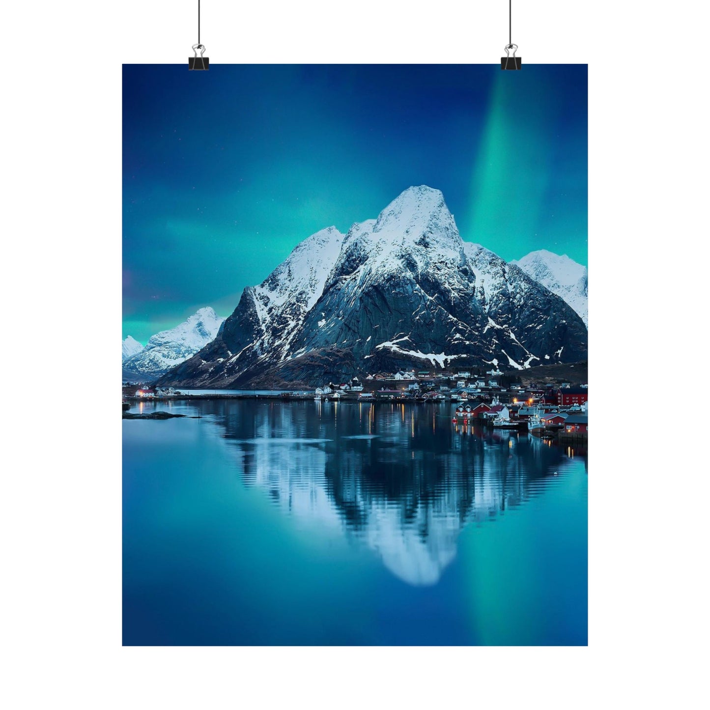Scenic view of a mountain reflected in water with a dark blue sky.
