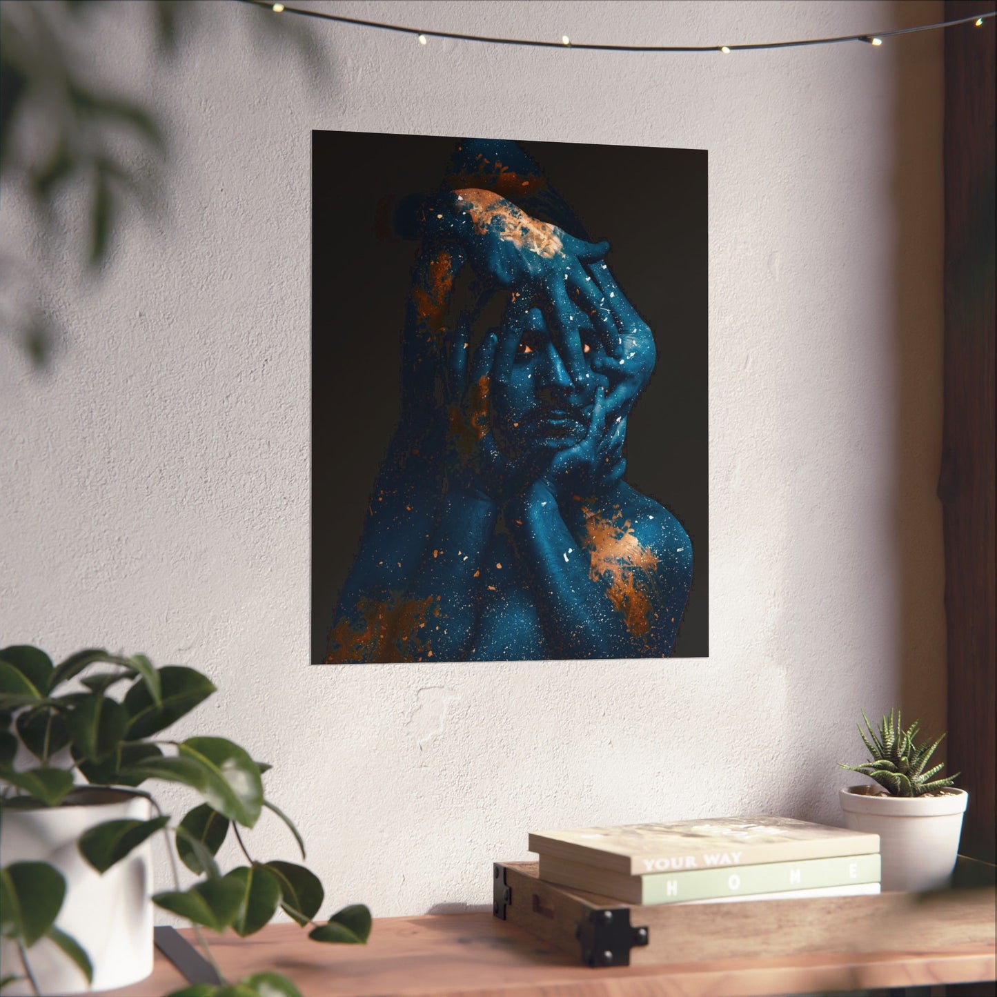 Abstract art piece on a wall with a desk and plants in the foreground