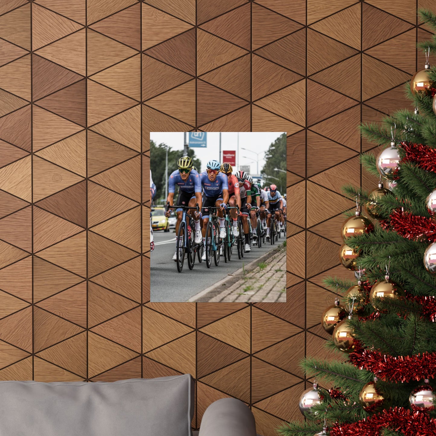 Bicycle race scene reflected in a mirror on a wooden wall with a Christmas tree to the right.