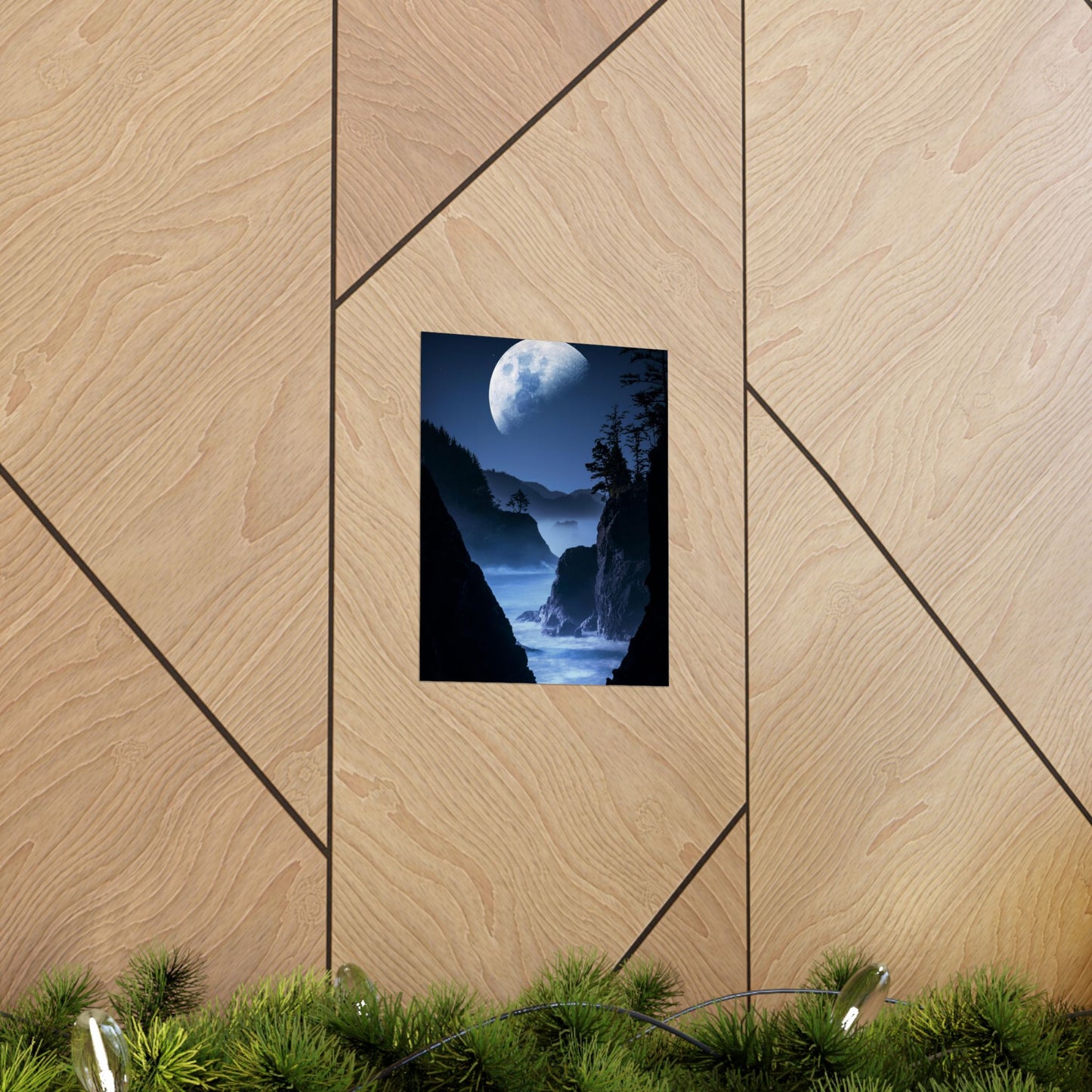 Framed artwork of a moonlit landscape on a wooden wall.