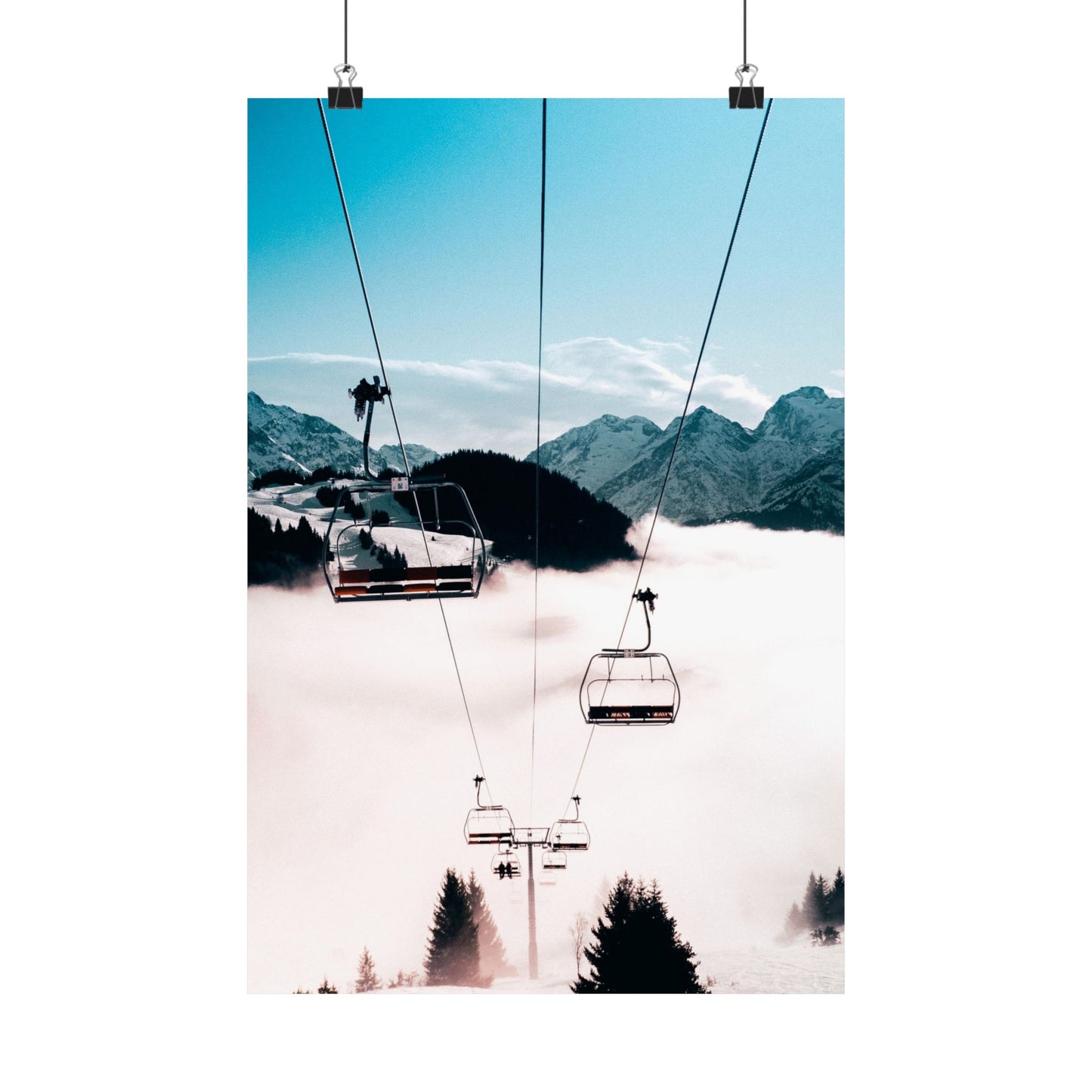 Ski lift with mountains and clouds in the background
