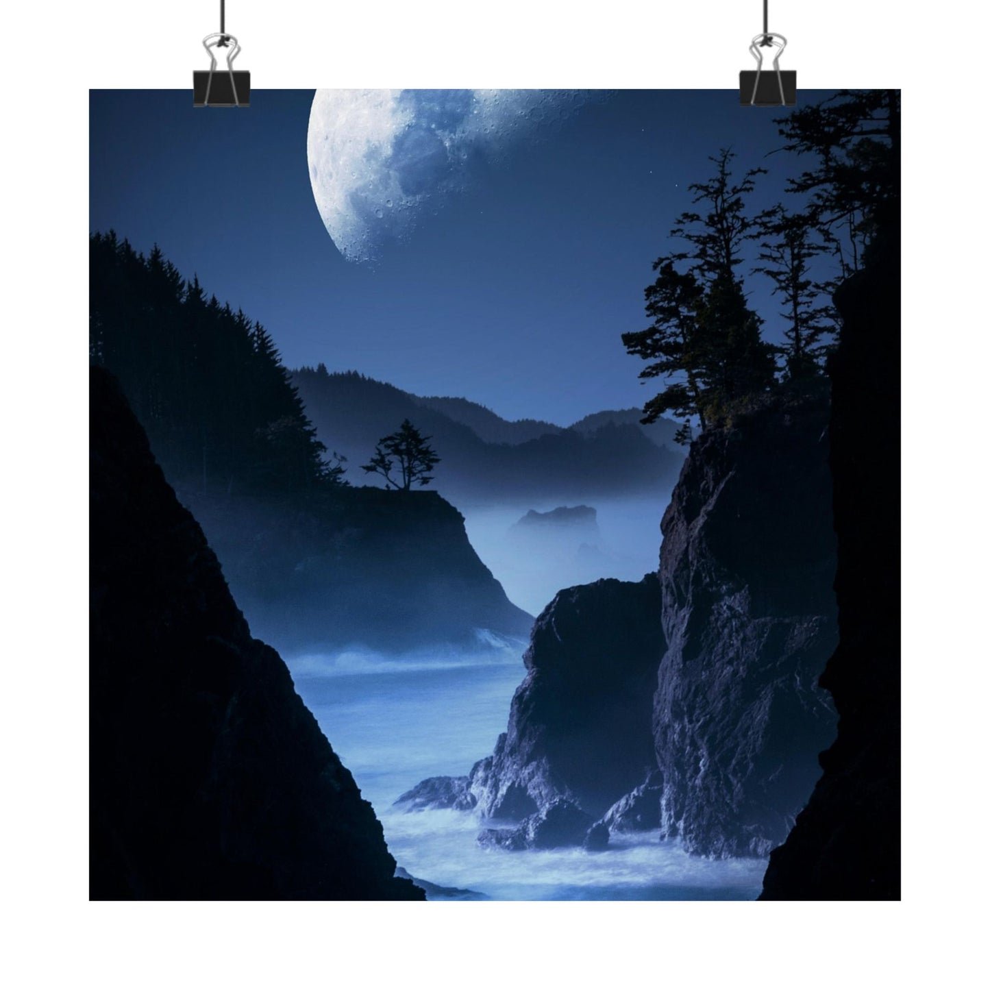 Majestic night scene of a mountainous coastline with a large moon in the sky.