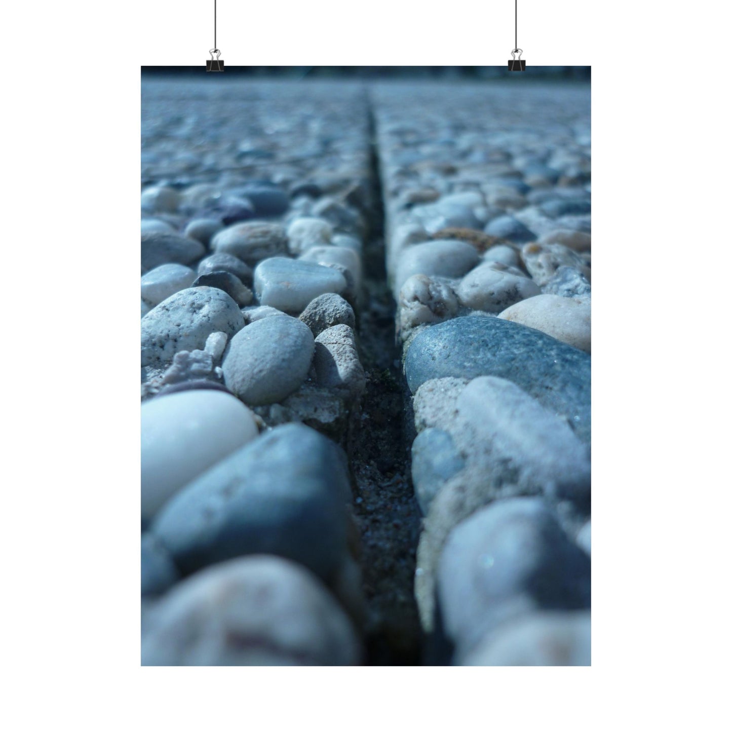Close-up of pebbles with a crack running through them on a white background