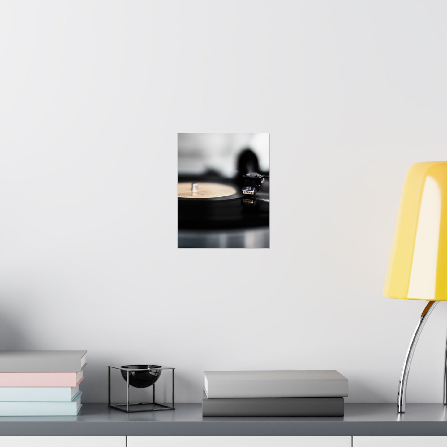 Modern interior with a yellow chair, books, and decorative items on a shelf.