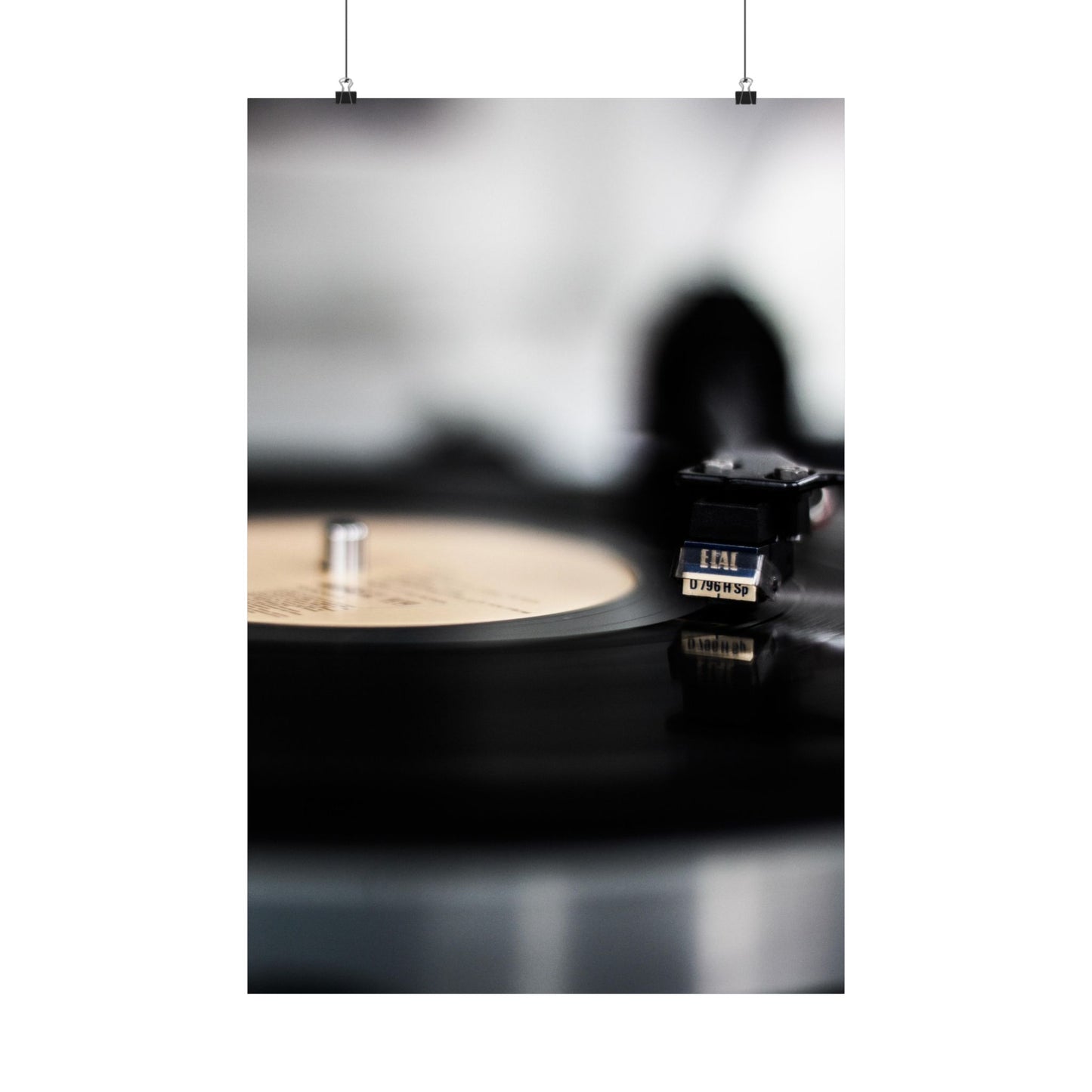 Silhouette of a person using a vinyl record player with a record on a white background