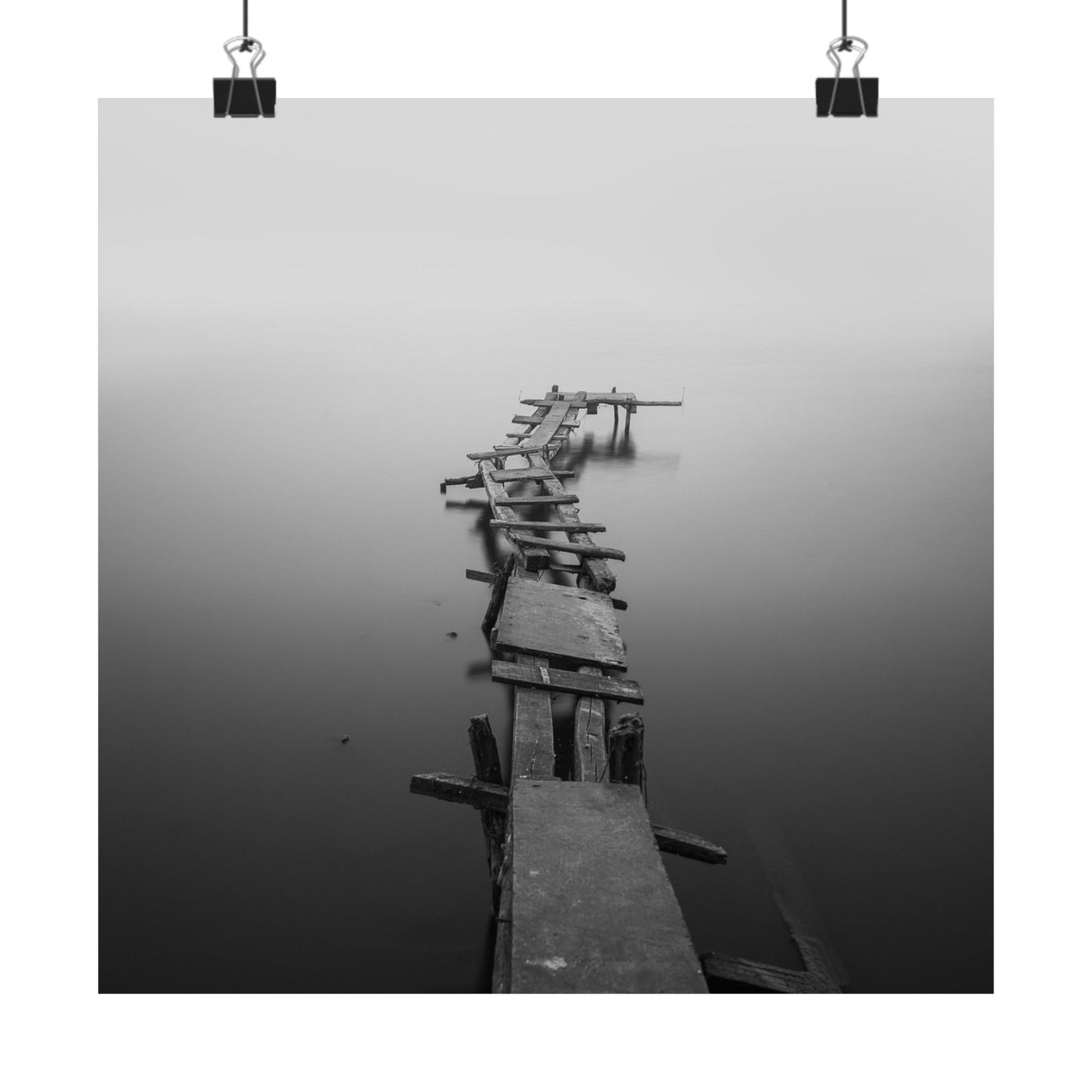 Long wooden pier extending into a foggy body of water