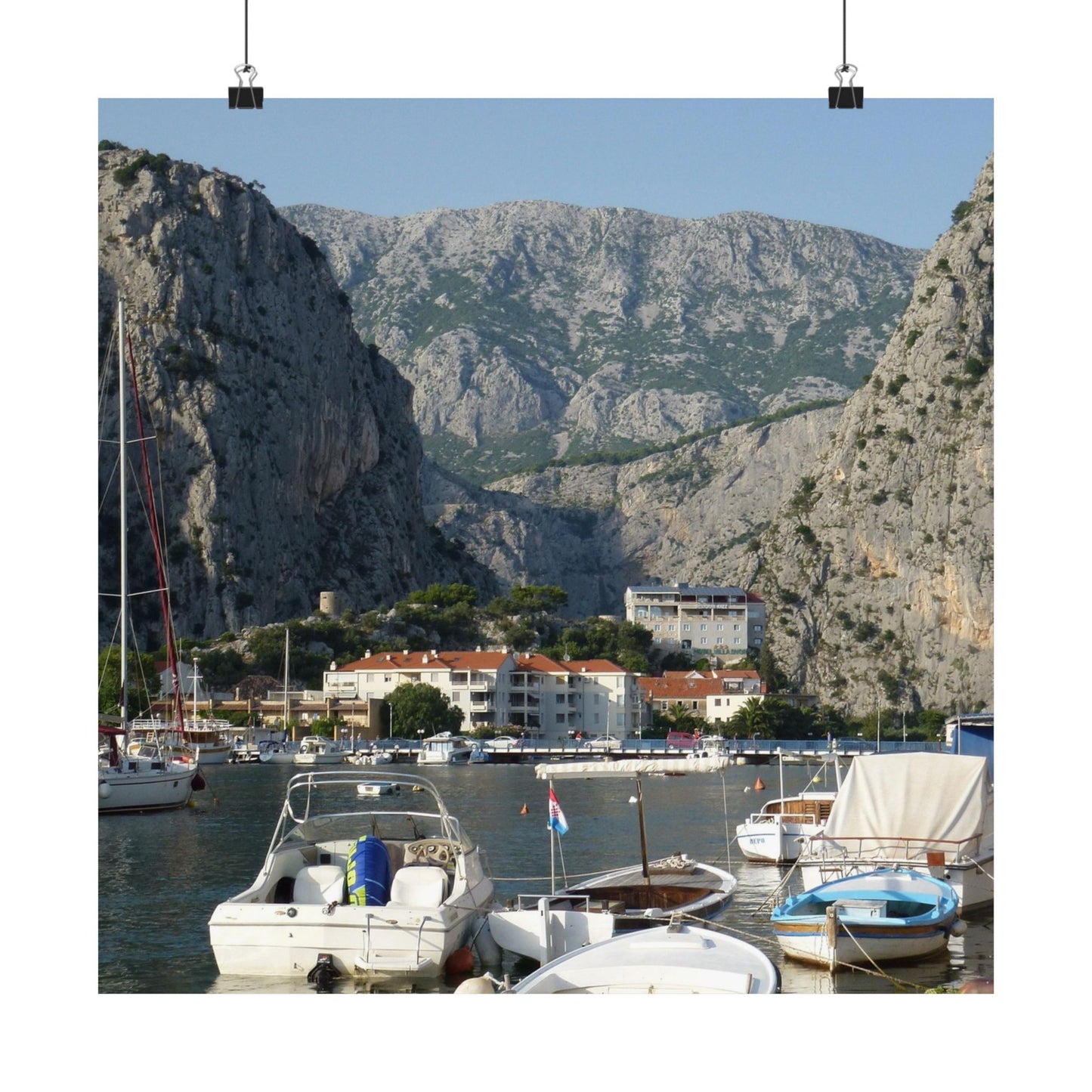 Harbor with boats and buildings against a mountainous background