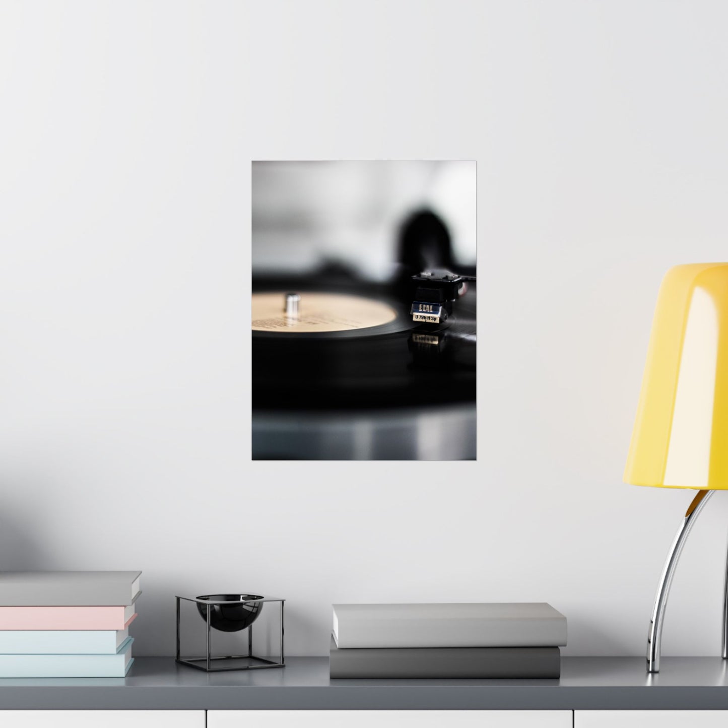 Modern interior design with a yellow lamp, books, and decorative items on a shelf.