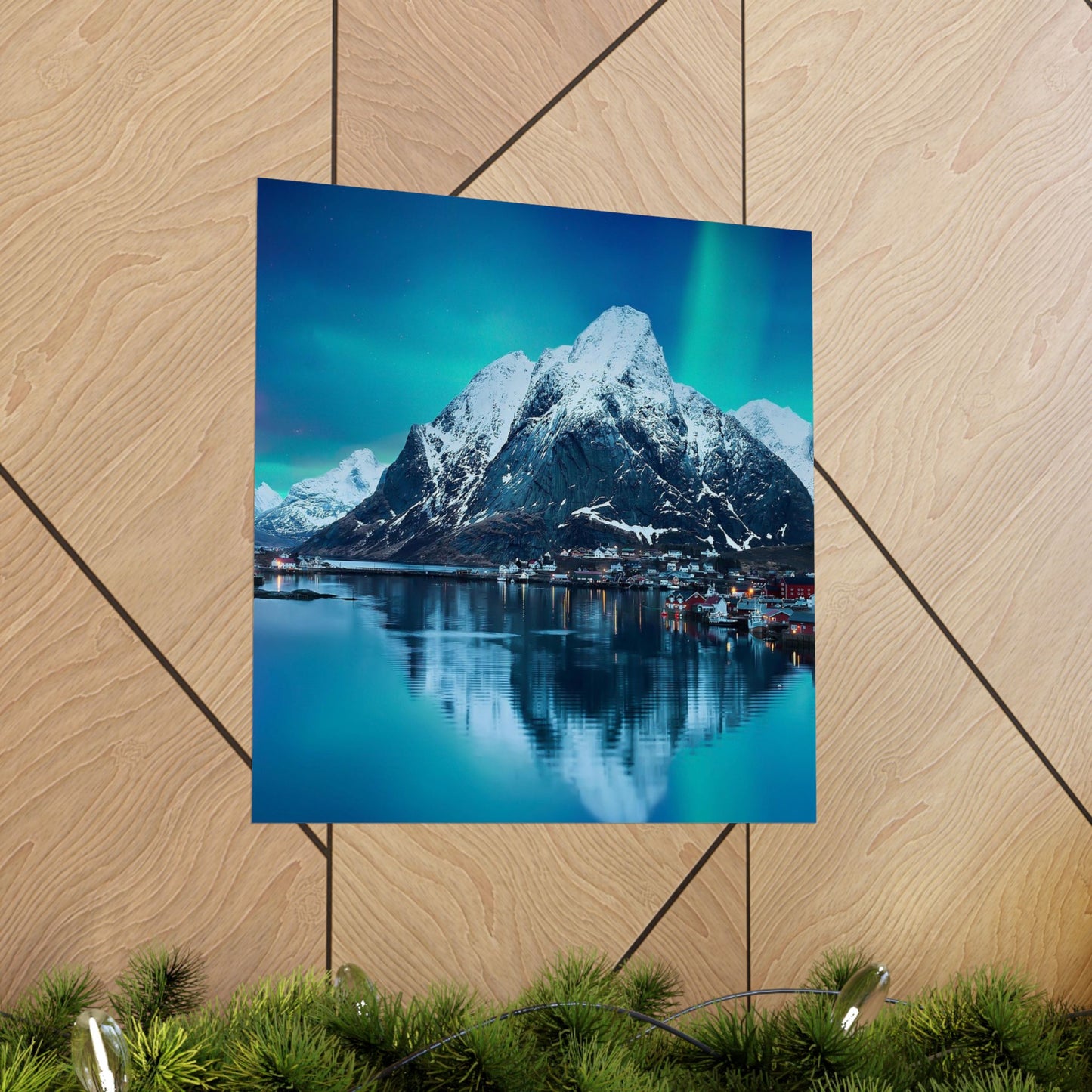 Poster of a mountain and lake scene on a wooden floor.