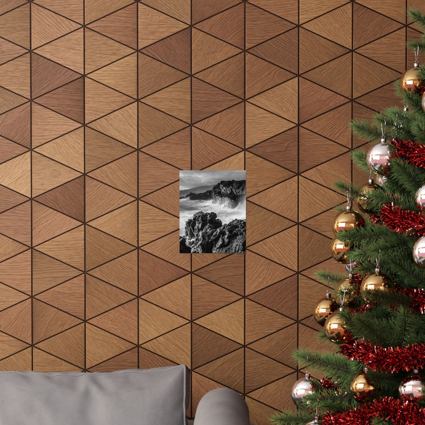 Wooden wall with geometric pattern, small black and white picture, and Christmas tree with decorations.