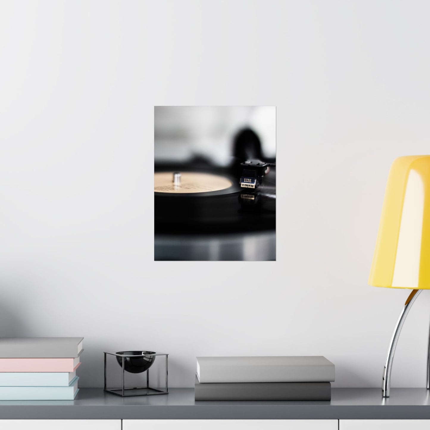 Modern interior with a yellow lamp, books, and decorative items on a shelf.