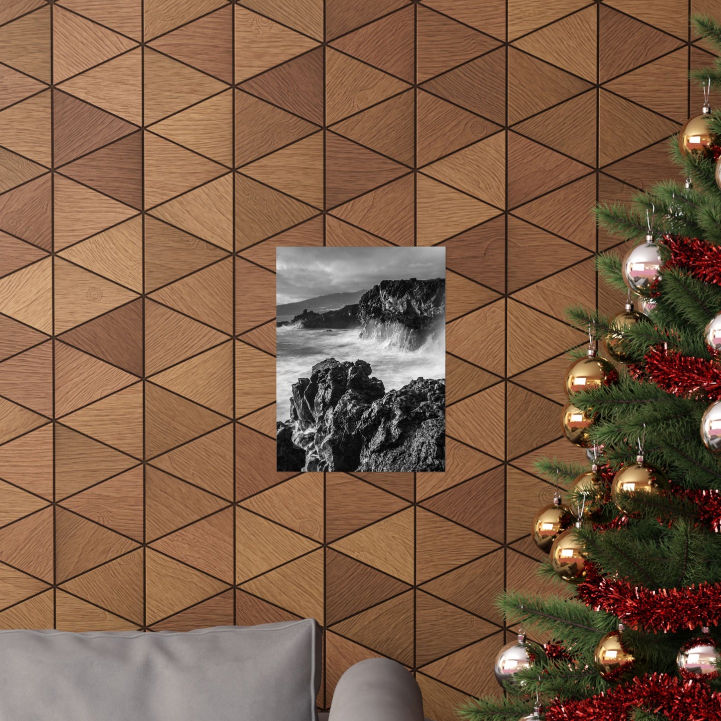 Wooden wall with geometric pattern, framed picture, and Christmas tree with decorations.