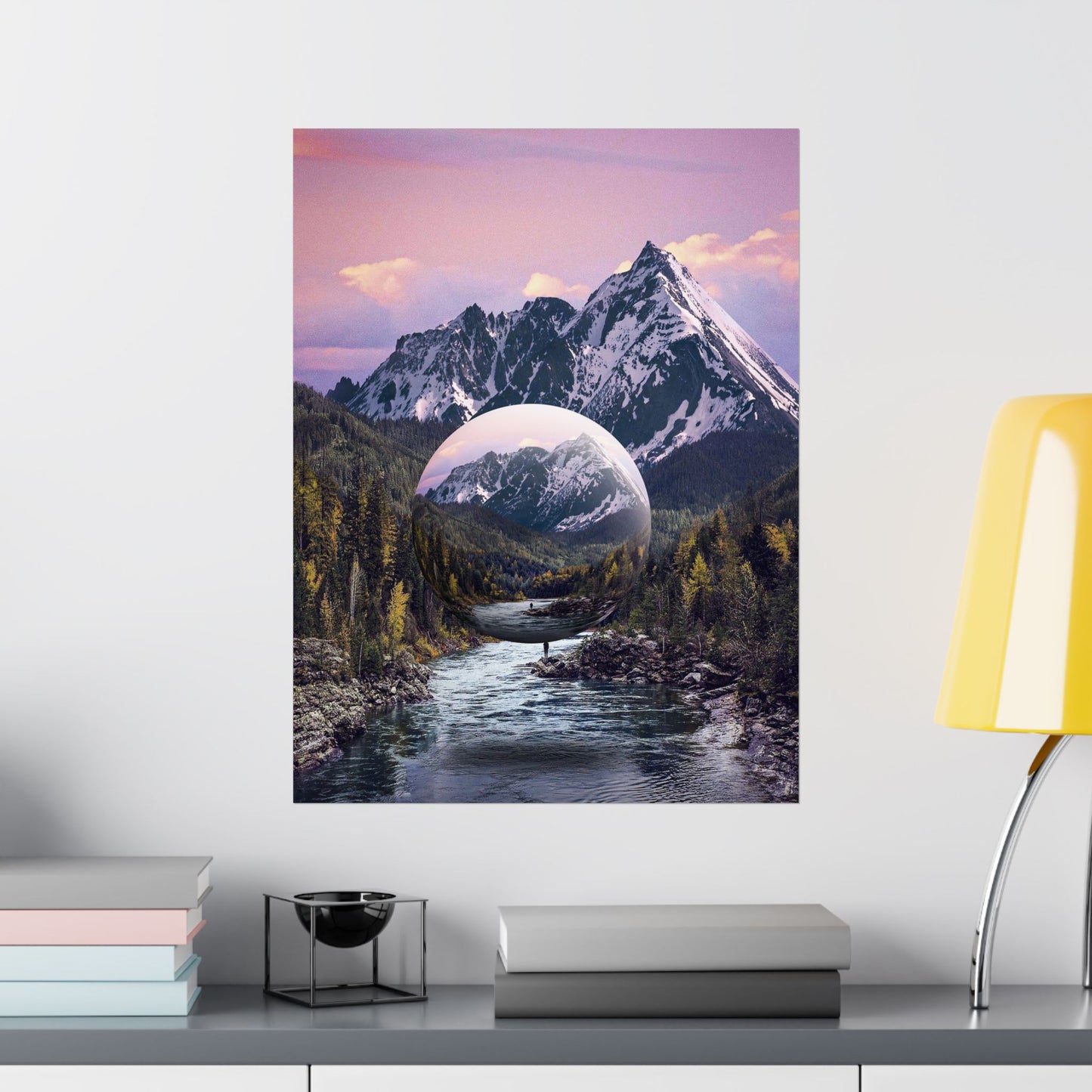 Framed artwork of a mountain landscape with a reflective lake on a wall above a shelf.