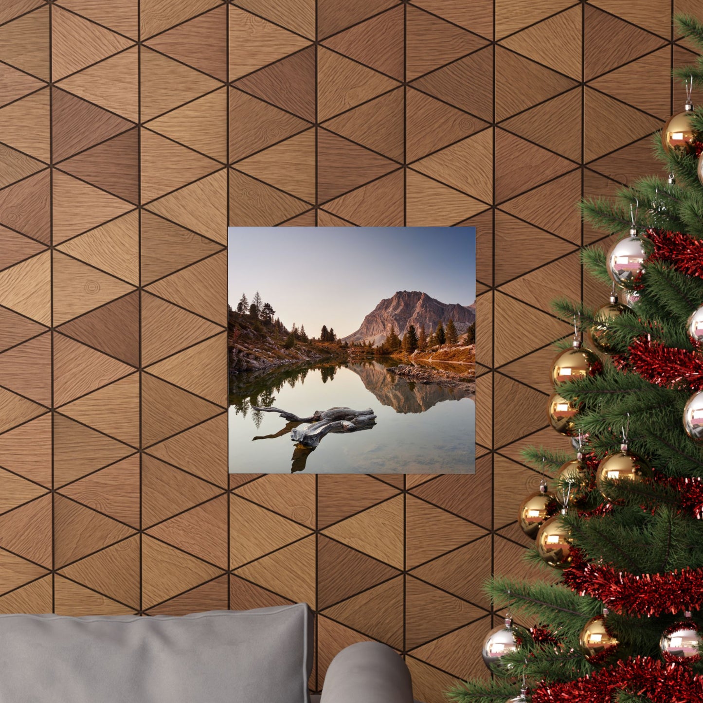 Decorative wall with geometric wood pattern, framed landscape print, and Christmas tree.