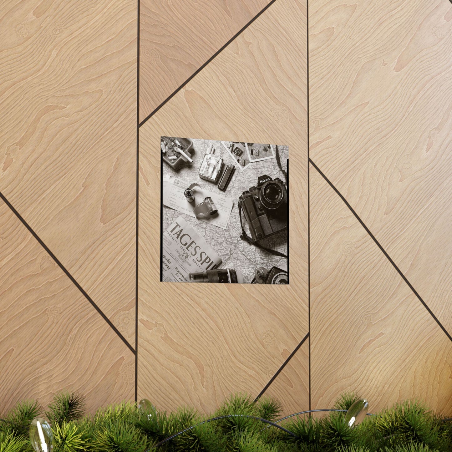 Decorative wall art with a black and white photo of vintage cameras on a wooden panel.