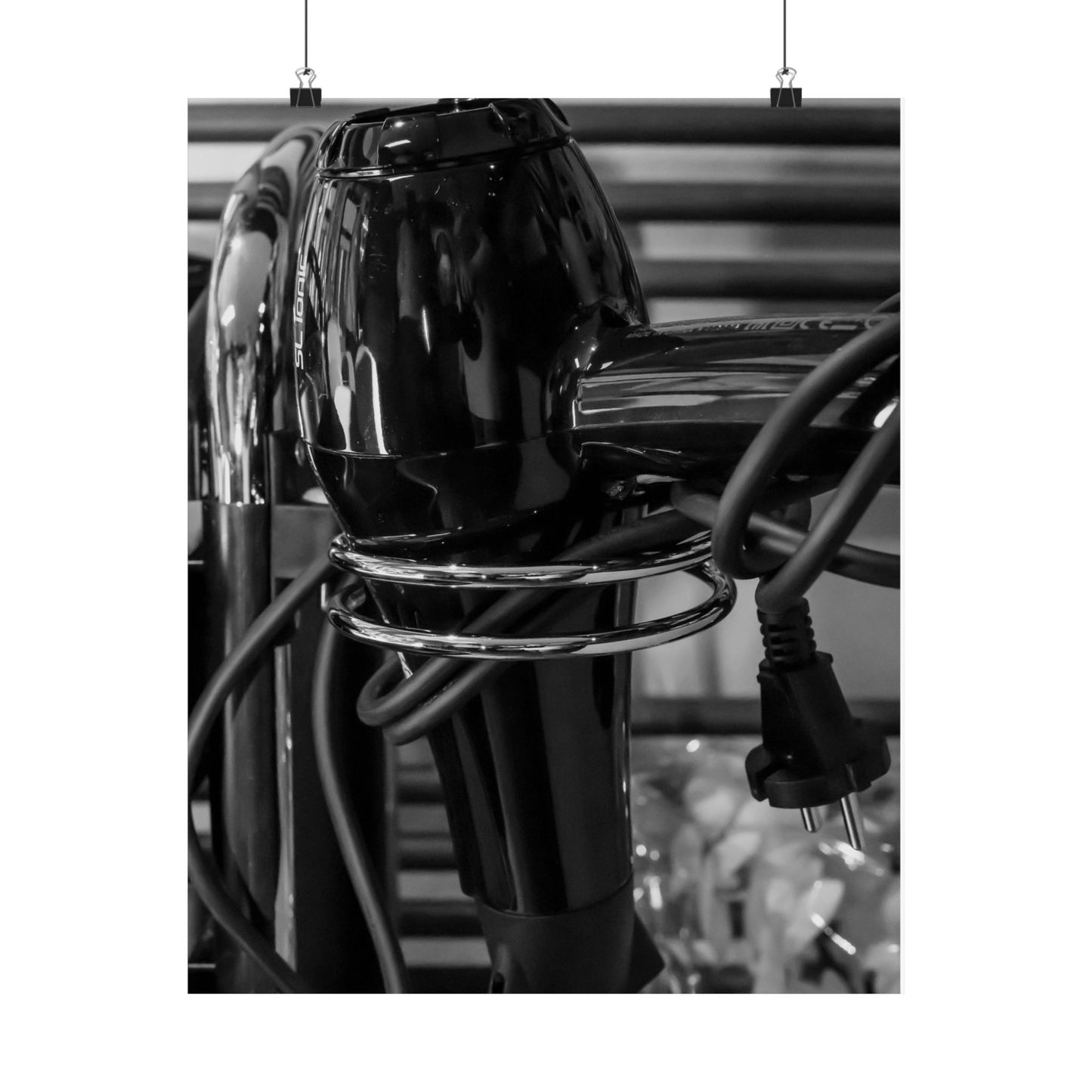 Black hair dryer with multiple cords on a blurred background