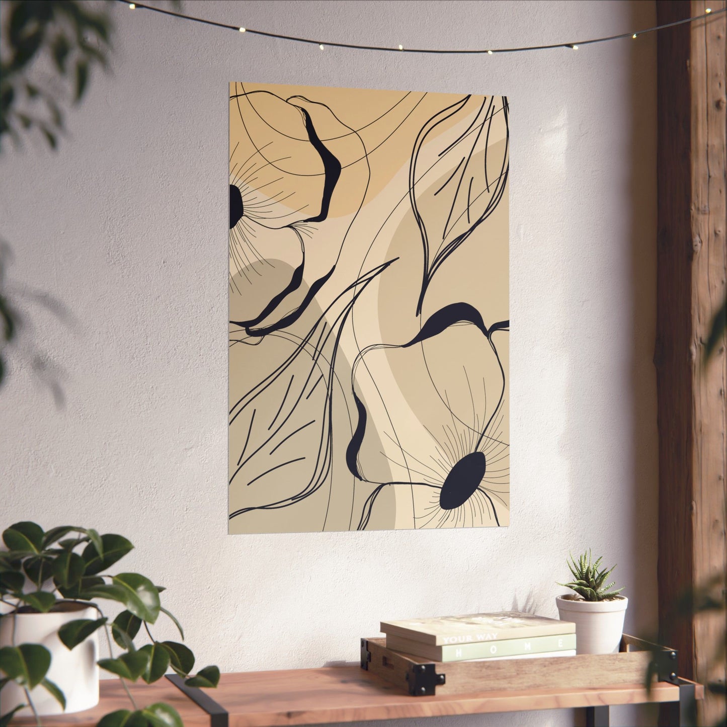 Abstract floral artwork on a wall with a wooden table and plants below.