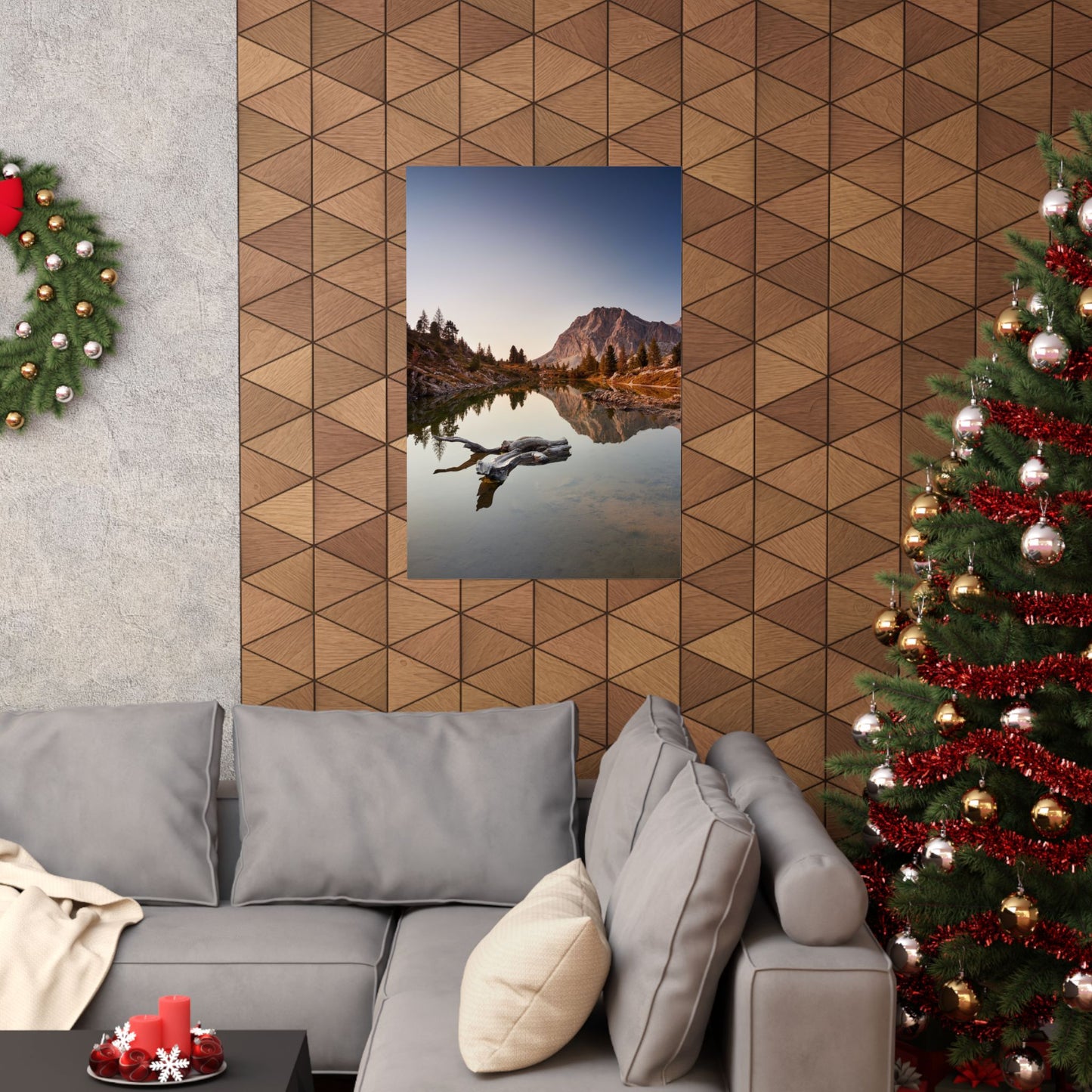Living room with a Christmas tree, gray sofa, and wall art of a mountain landscape.