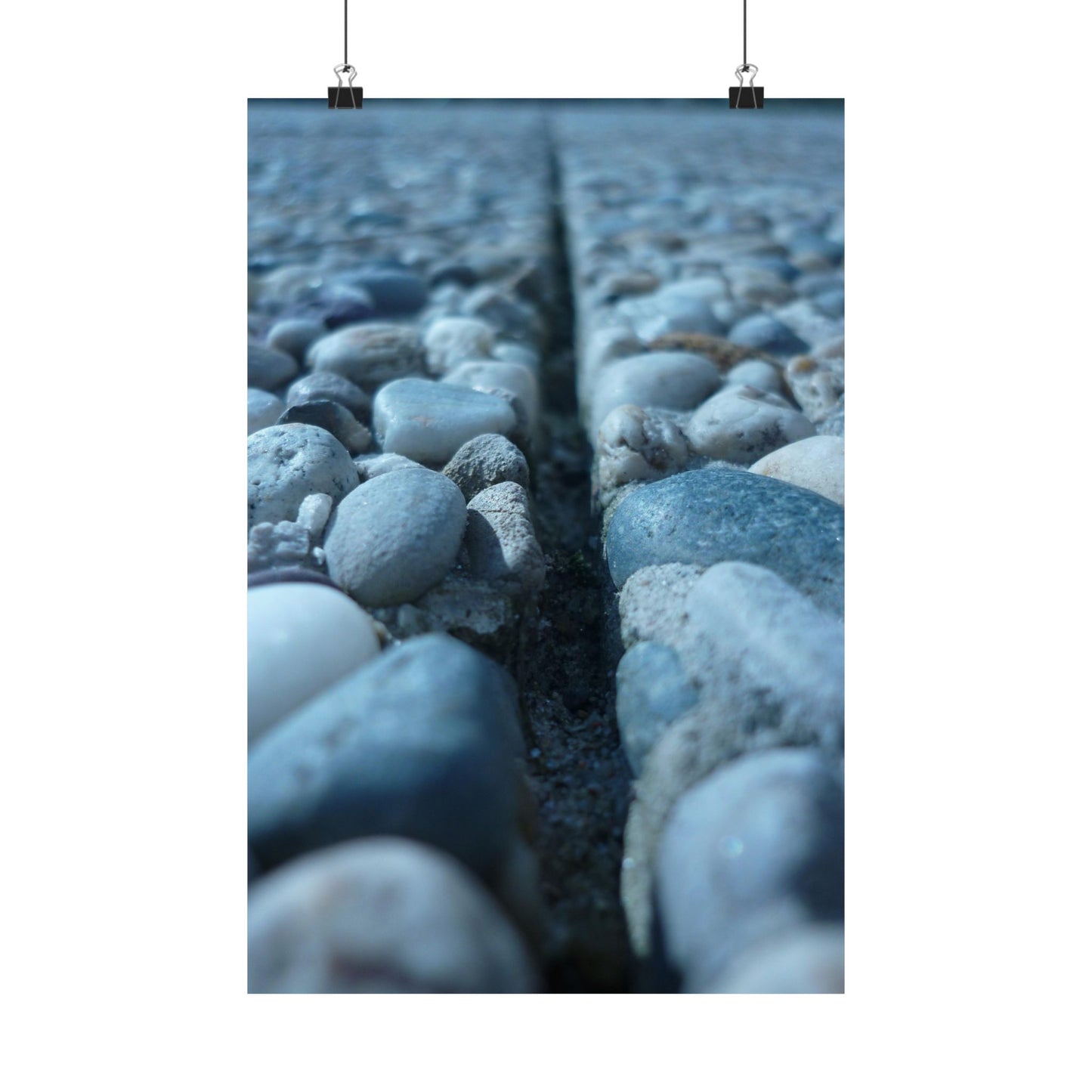 Close-up of pebbles with a crack running through them, on a white background.