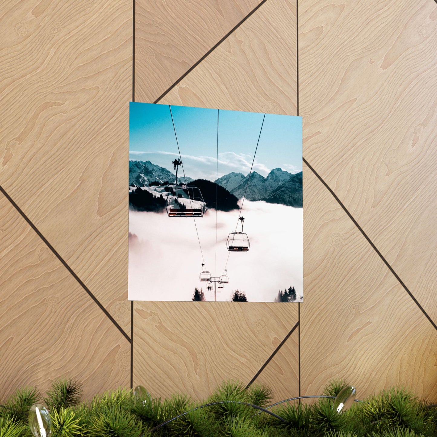 Poster of a mountain landscape with ski lifts on a wooden surface.