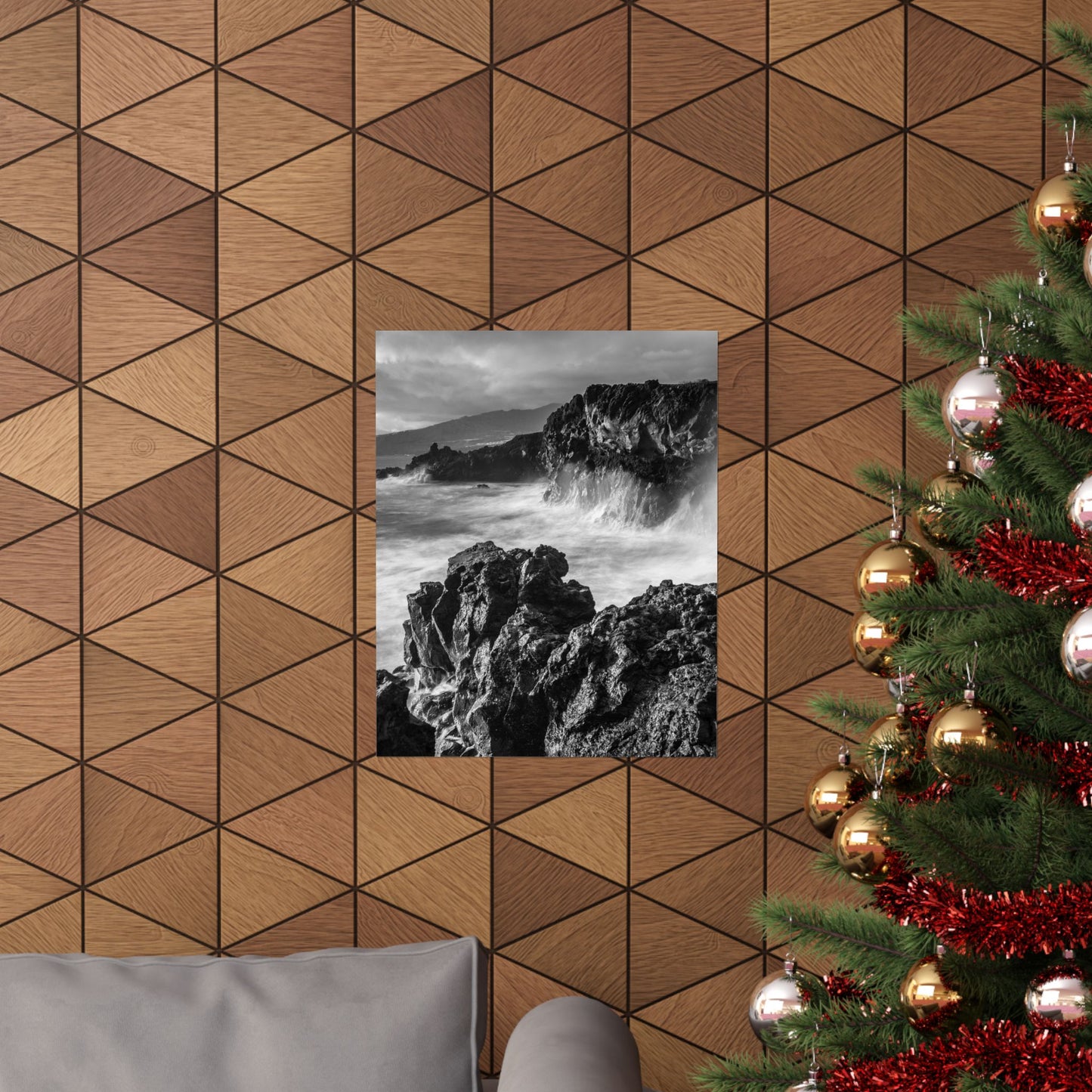Wooden wall with geometric pattern, framed black and white photo, and Christmas tree with decorations.