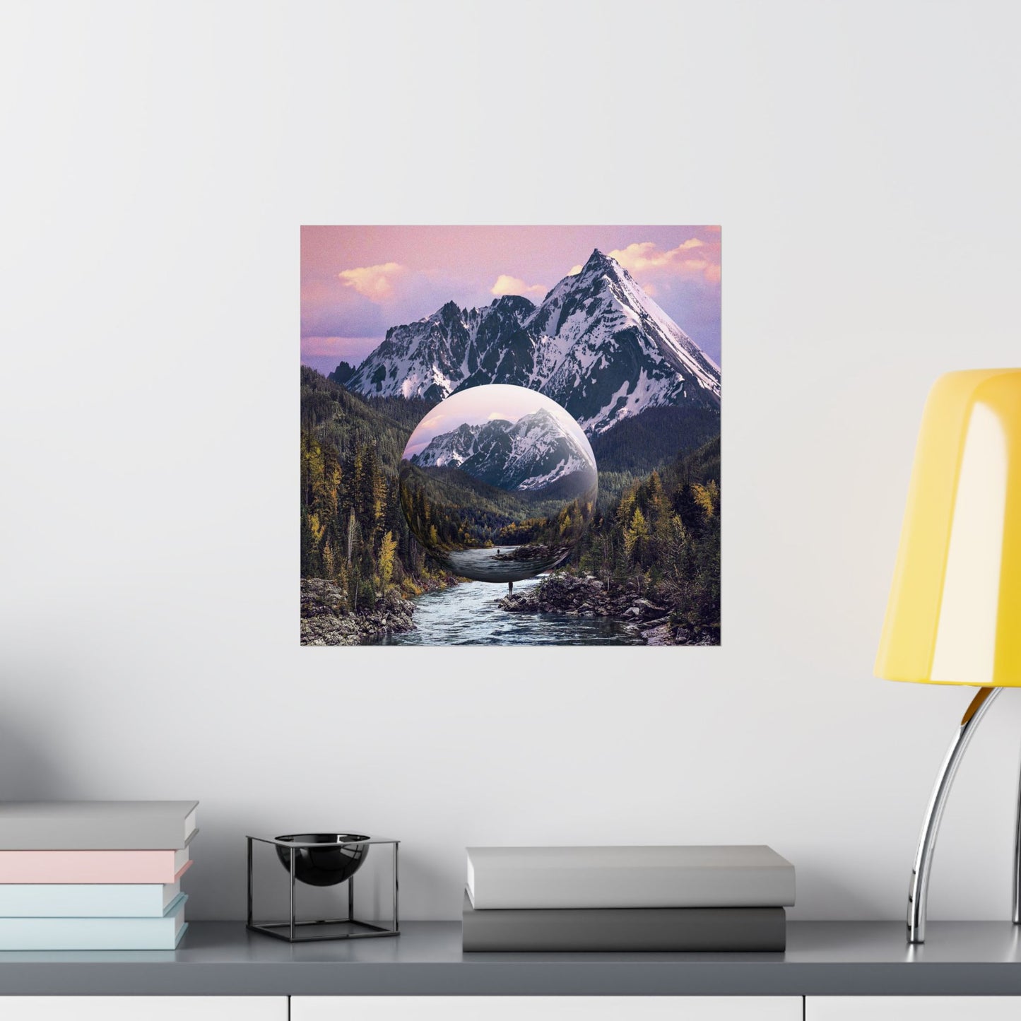 Framed artwork of a mountain landscape with a reflective lake on a wall above a shelf.
