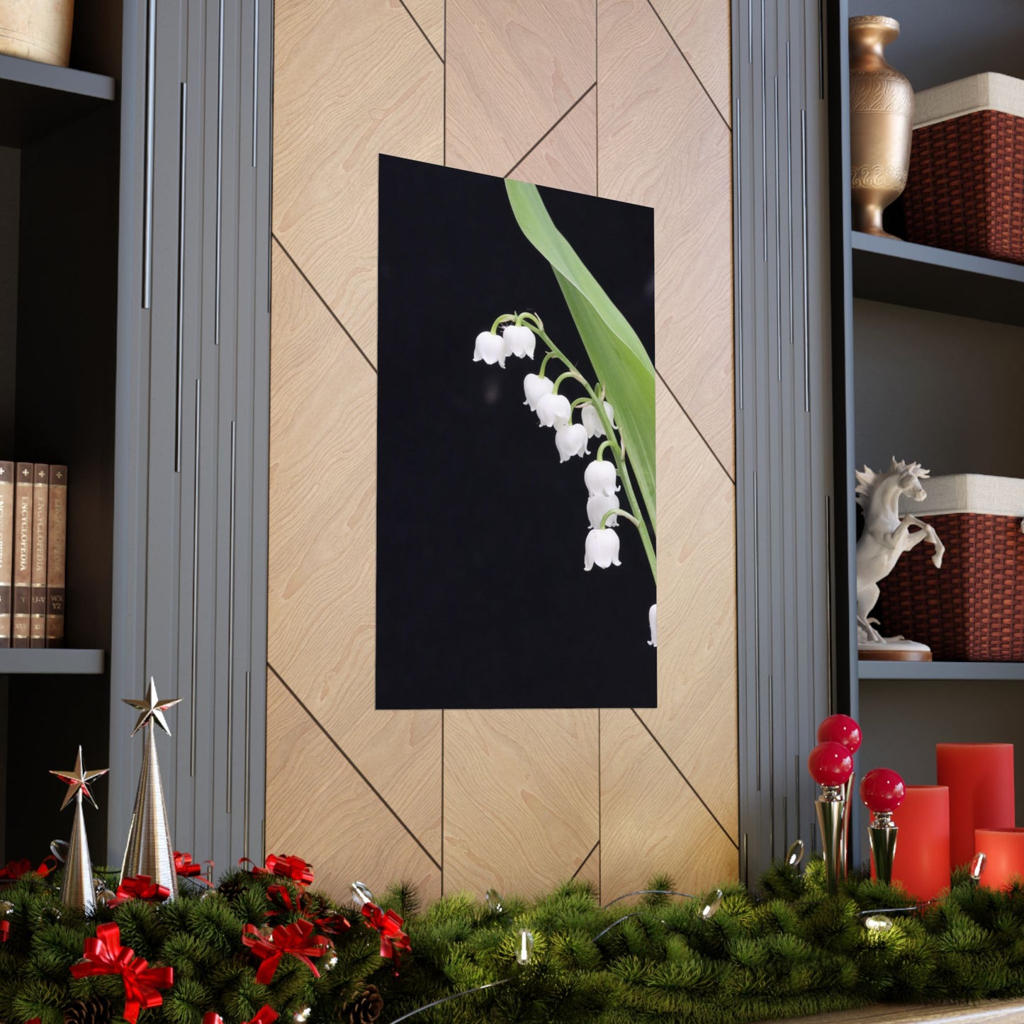 Decorative wall art of white flowers on a black background in a room with festive decorations.