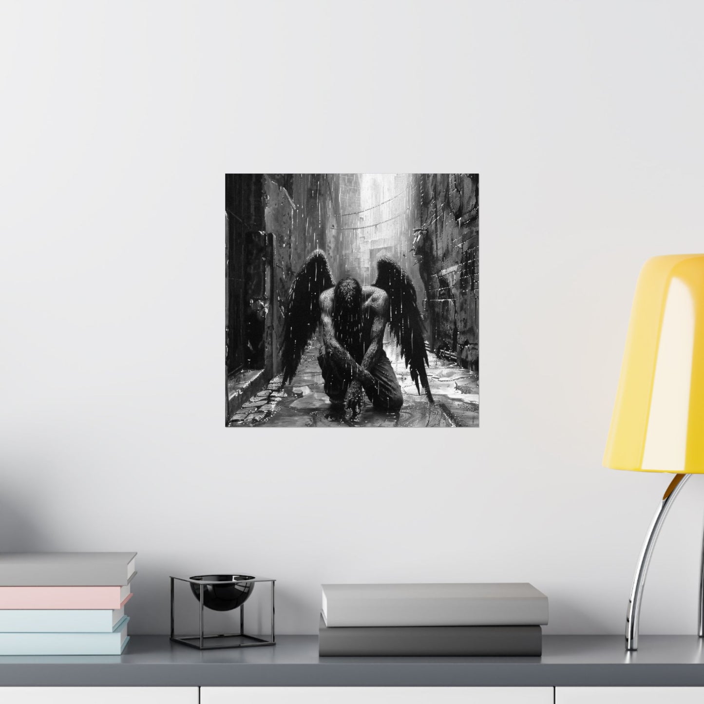 Black and white artwork of an angel with a scythe on a wall above a shelf.