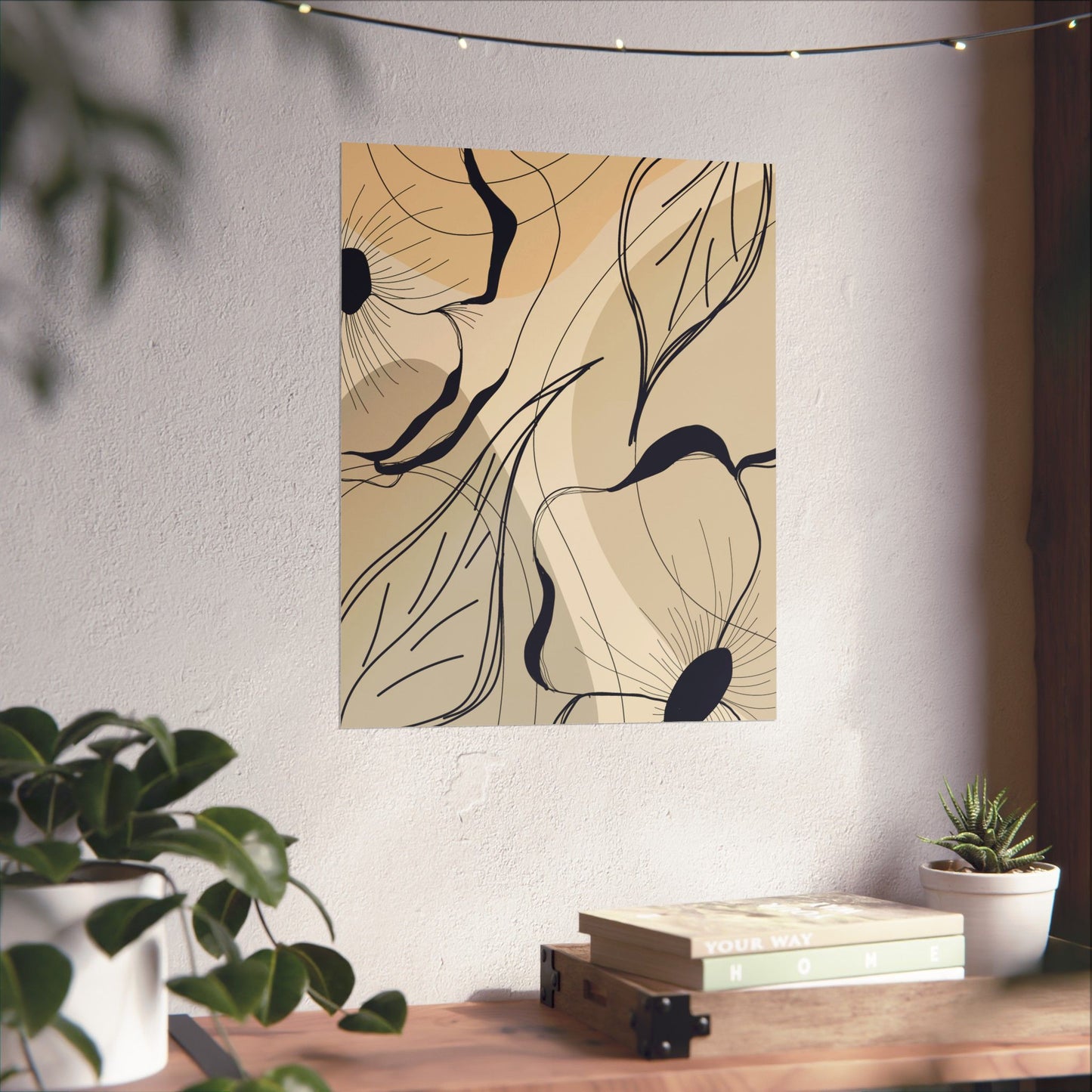 Abstract floral artwork on a wall with plants and books below