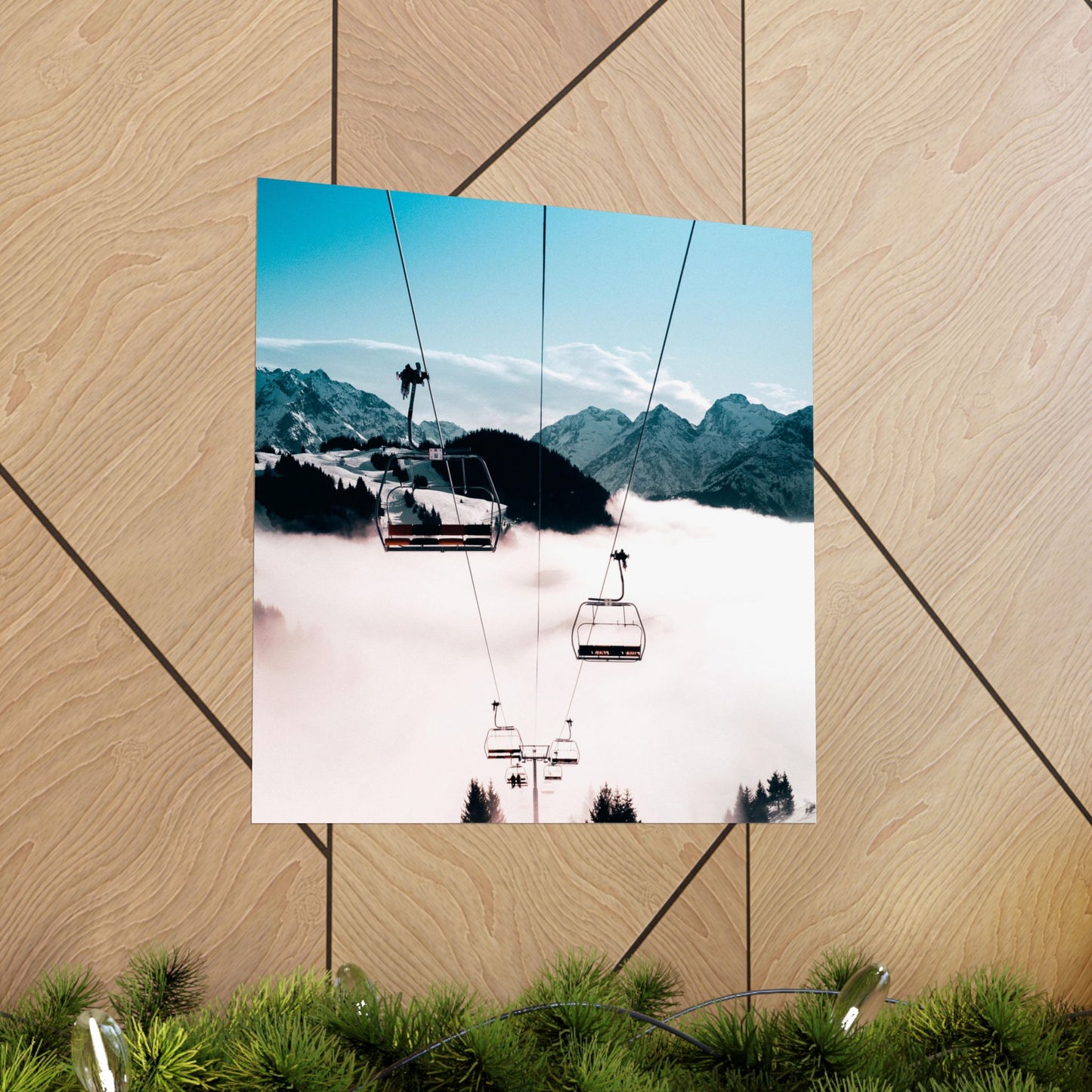 Ski lift with mountains and clouds in the background on a wooden surface